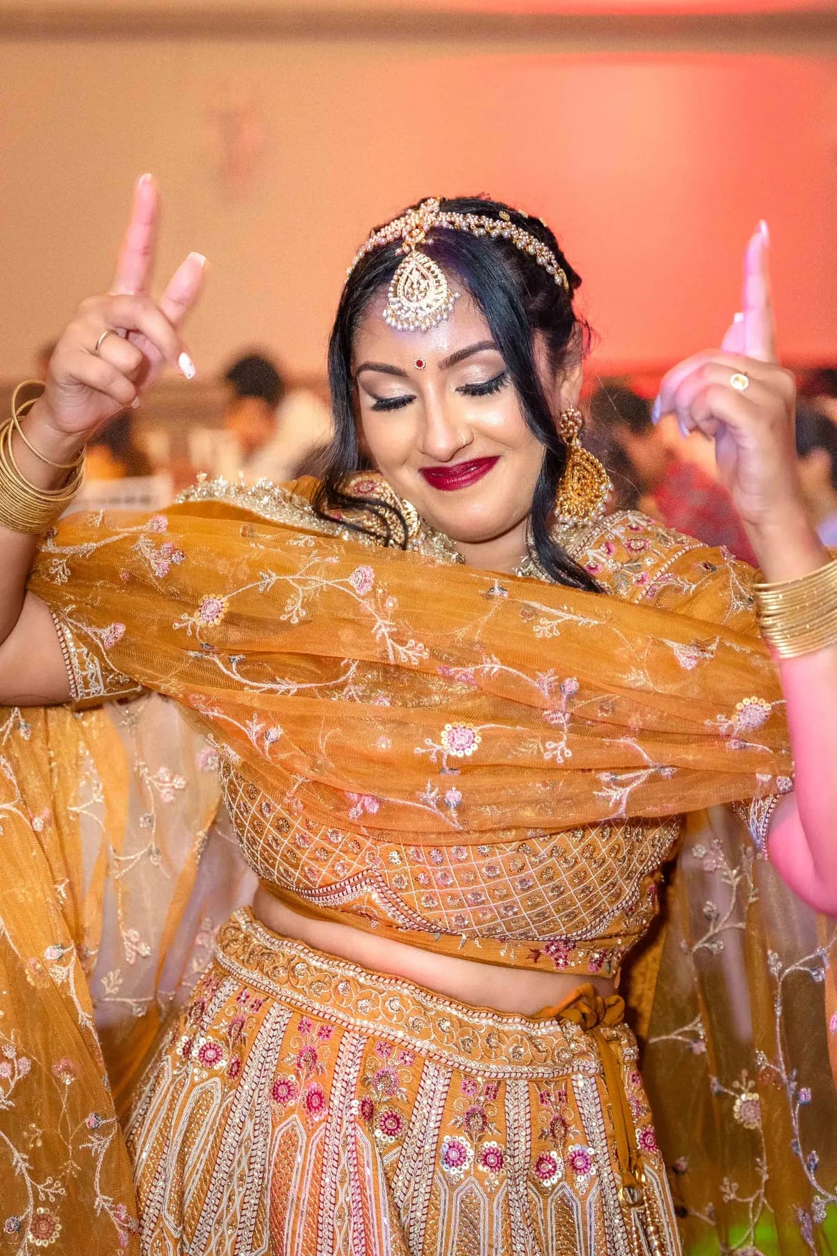 A guest dancing at Jessie and Erin’s Haldi celebration.