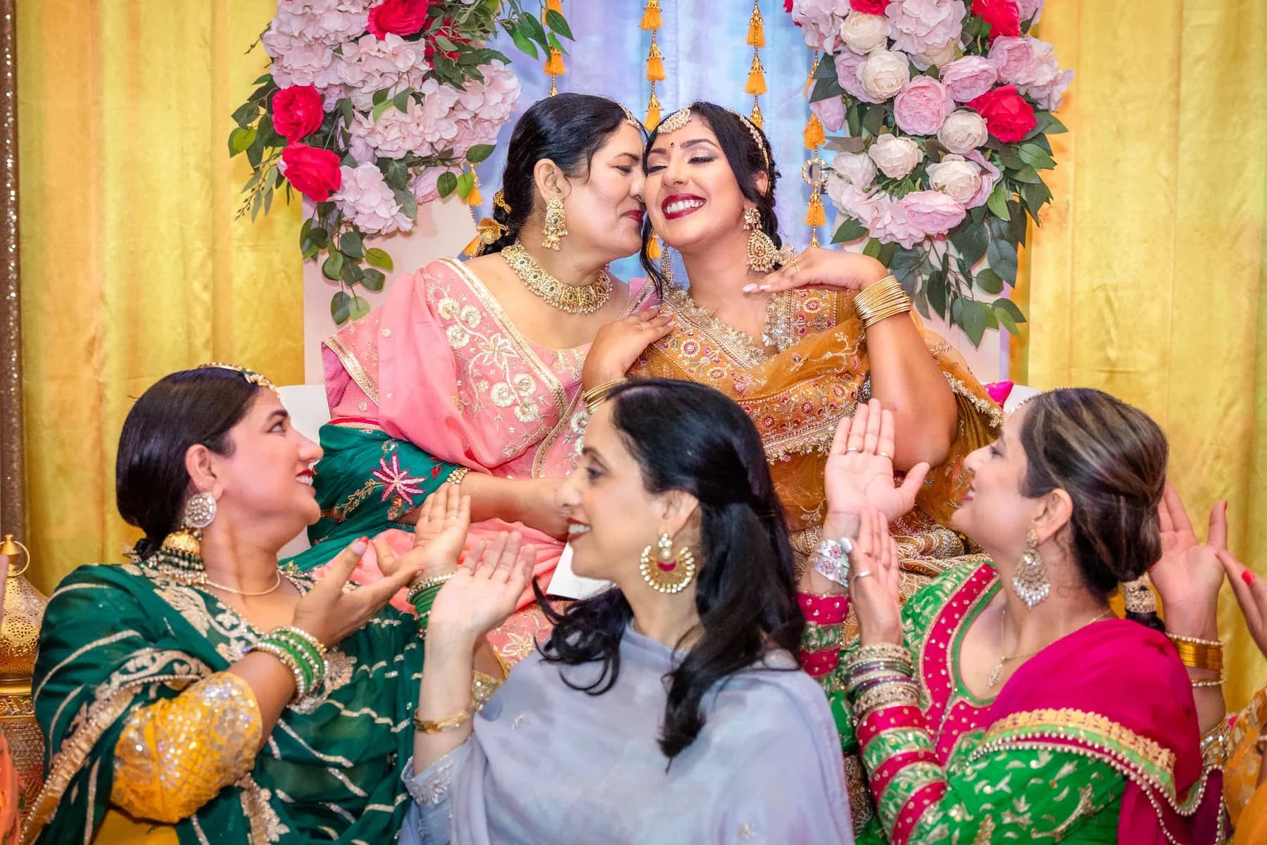 Guests sharing an affectionate moment at Jessie and Erin’s Haldi celebration.