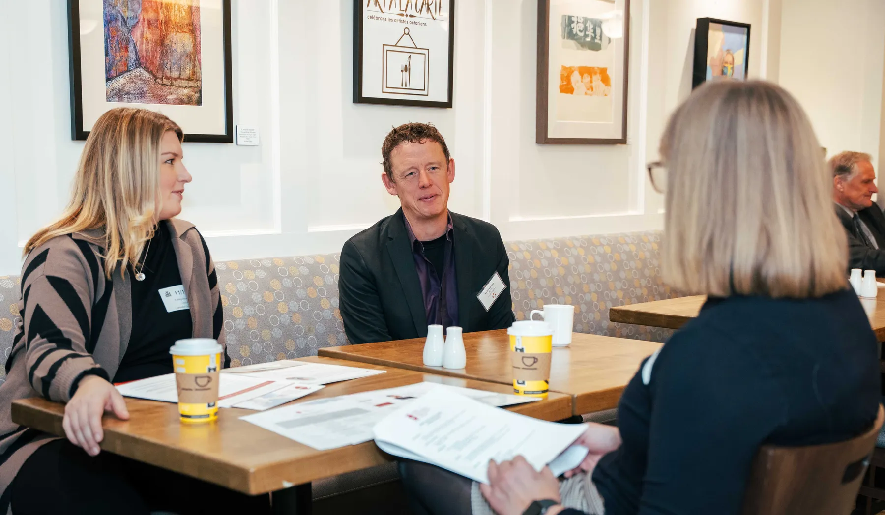 Participants meeting around tables at the NPAO event at Queen’s Park.