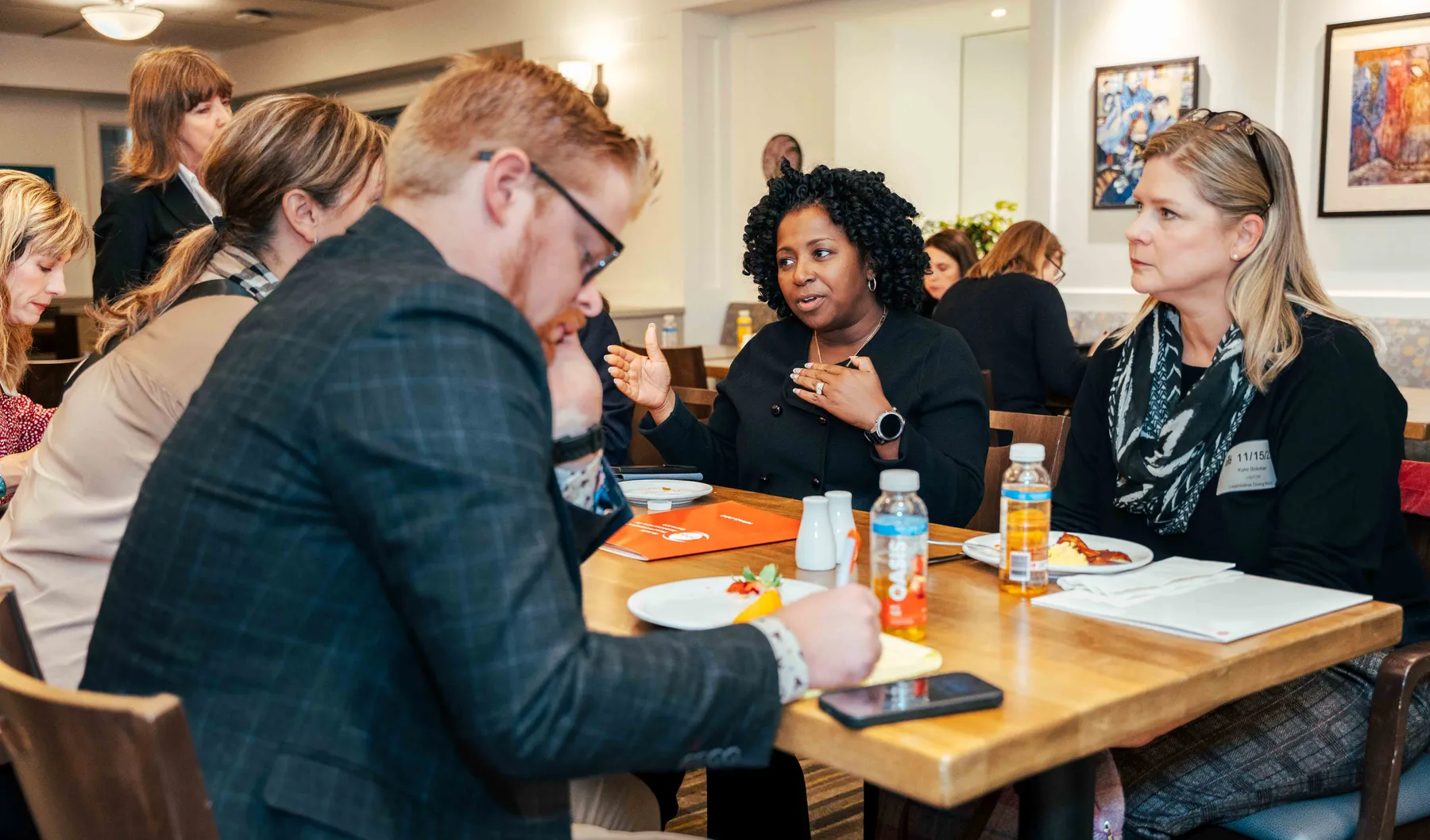 Participants meeting around a table at the NPAO event at Queen’s Park.
