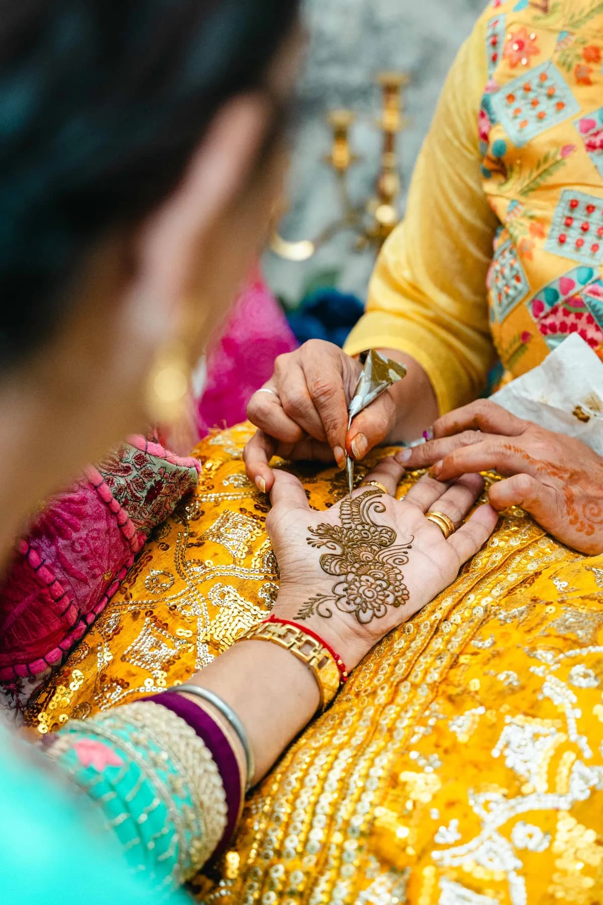 Decorated hands during the ceremony at Aaron’s Haldi celebration.