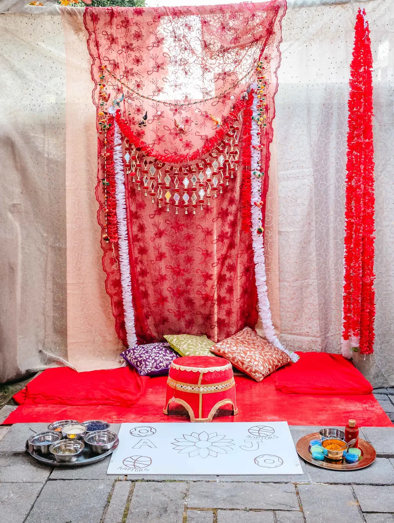 The decorated ceremony backdrop at Aaron’s Haldi celebration.