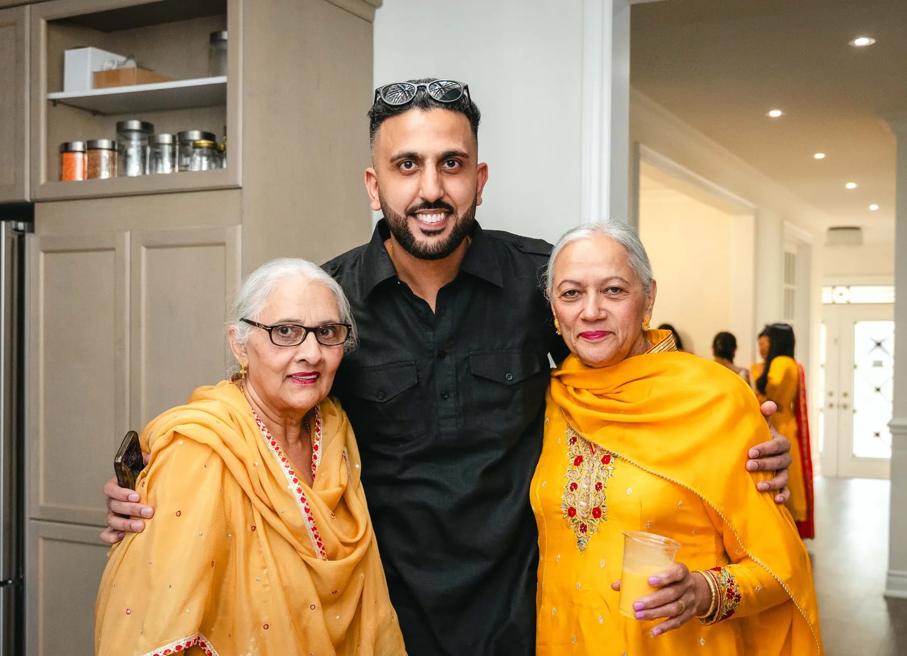 Guests talking and posing together at Aaron’s Haldi celebration.