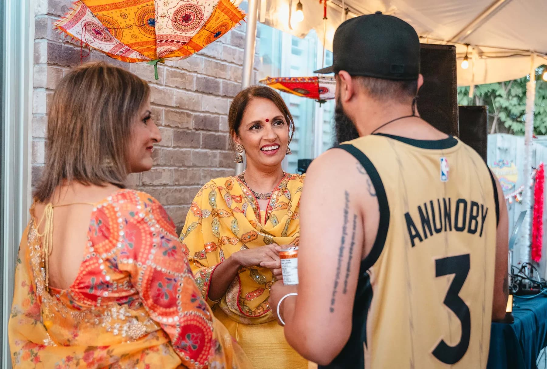 Guests in conversation at Aaron’s Haldi celebration.