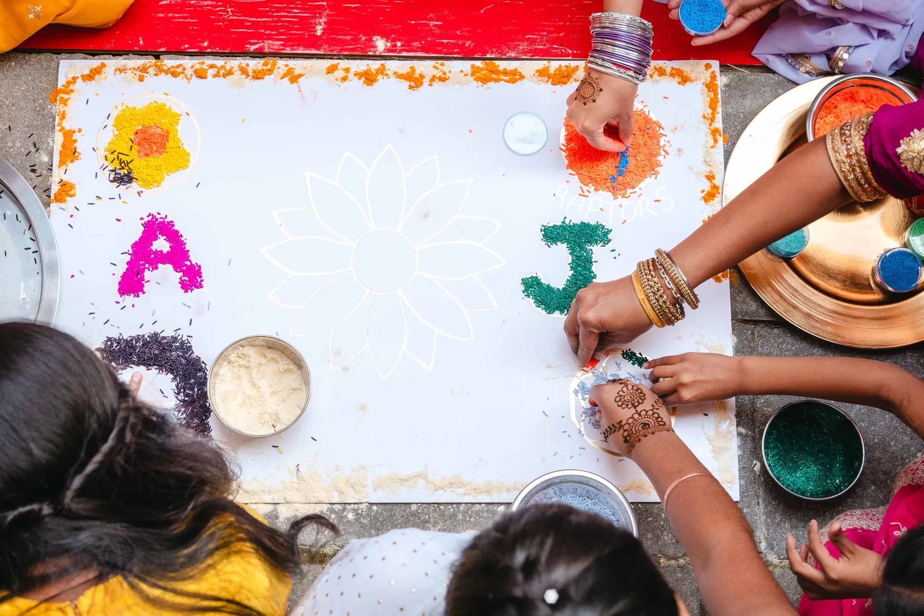 Colourful ceremonial artwork viewed from above at Aaron’s Haldi celebration.