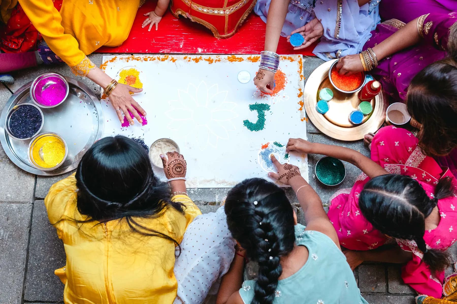 Colourful ceremonial artwork viewed from above at Aaron’s Haldi celebration.