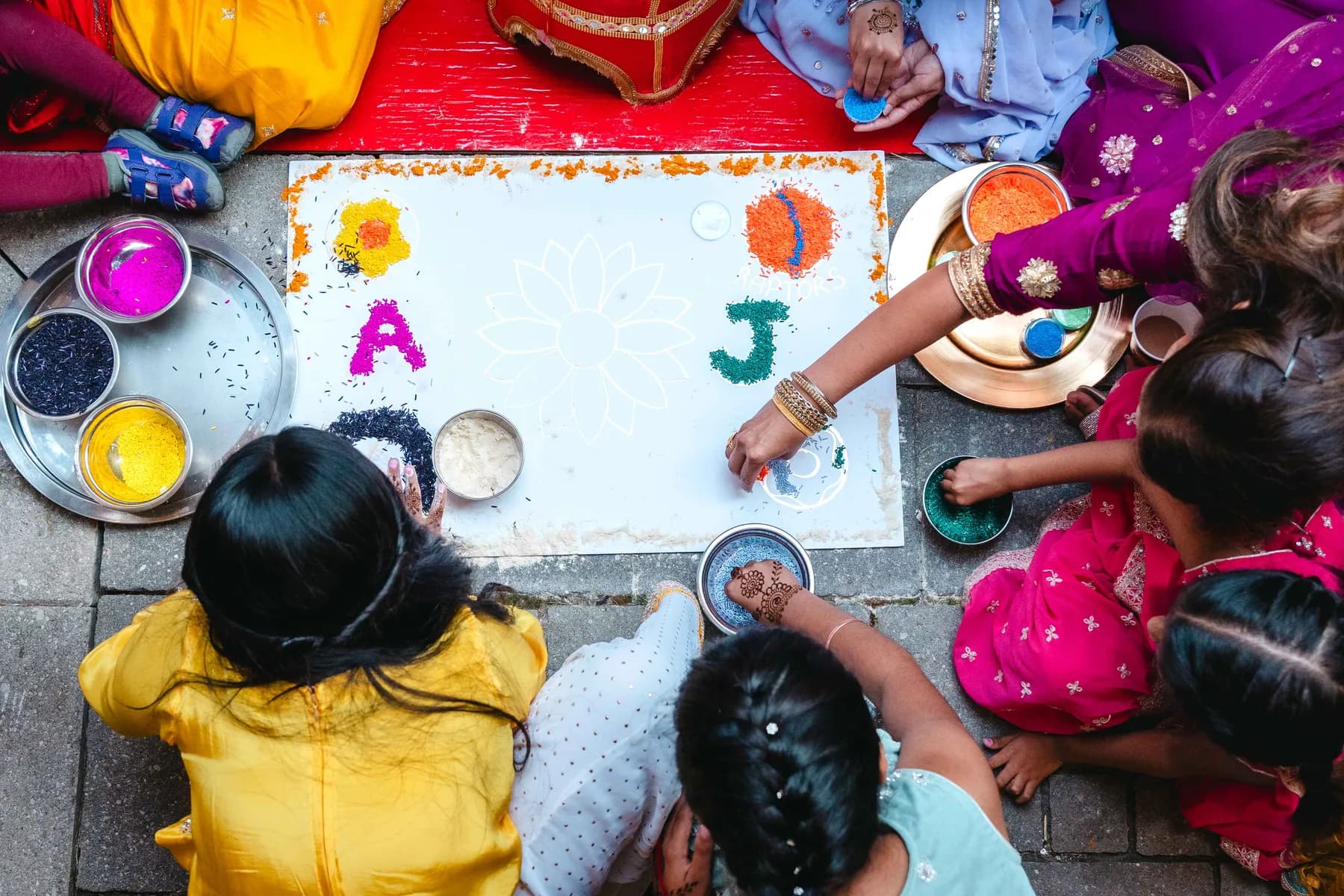 Colourful ceremonial artwork viewed from above at Aaron’s Haldi celebration.