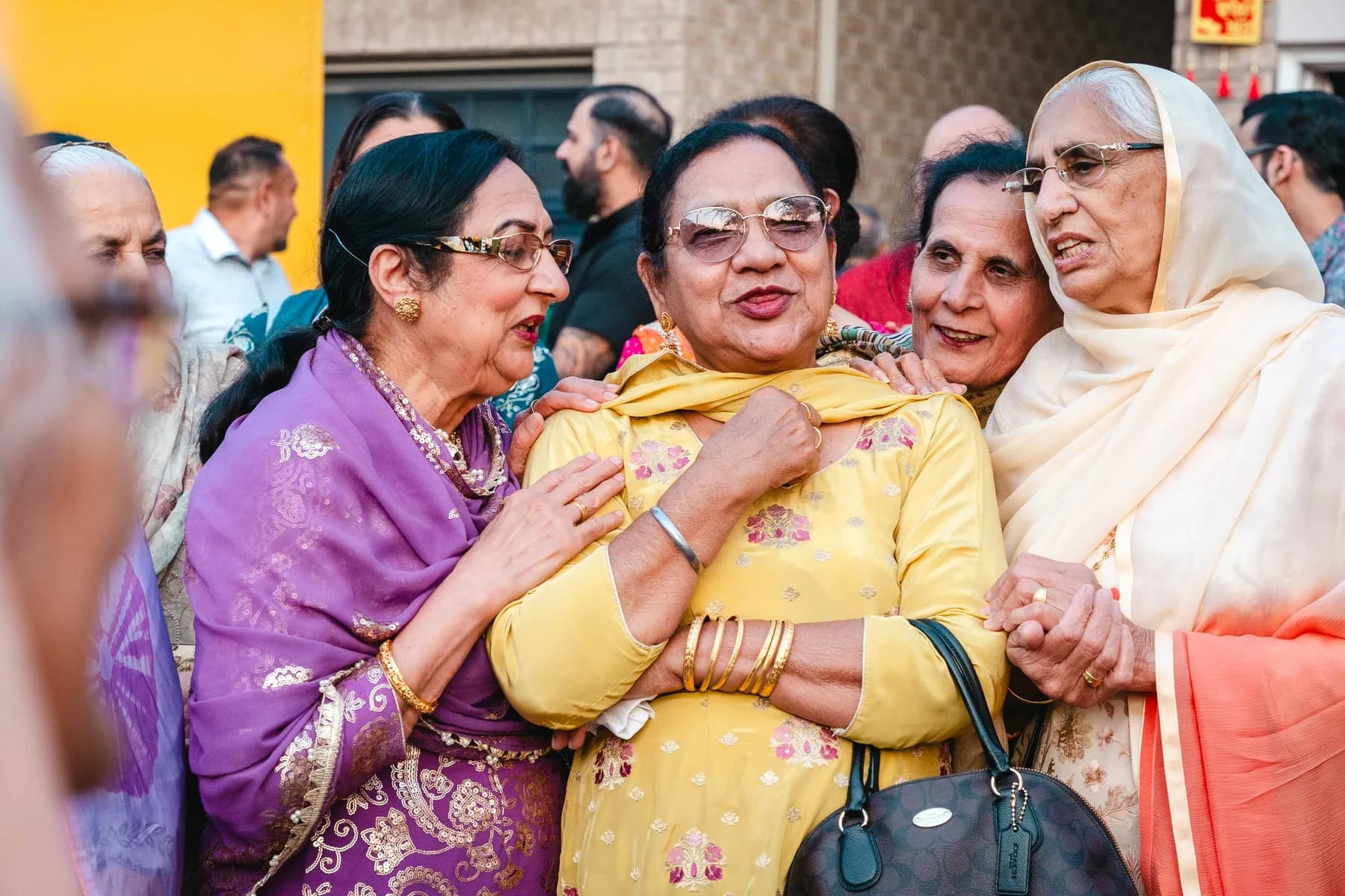 Guests greeting each other outdoors at Aaron’s Haldi celebration.
