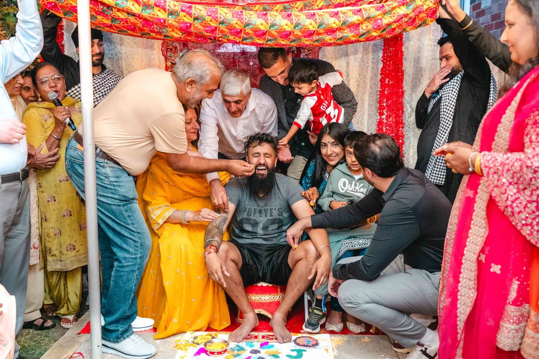Guests applying colour during the Haldi ceremony at Aaron’s Haldi celebration.