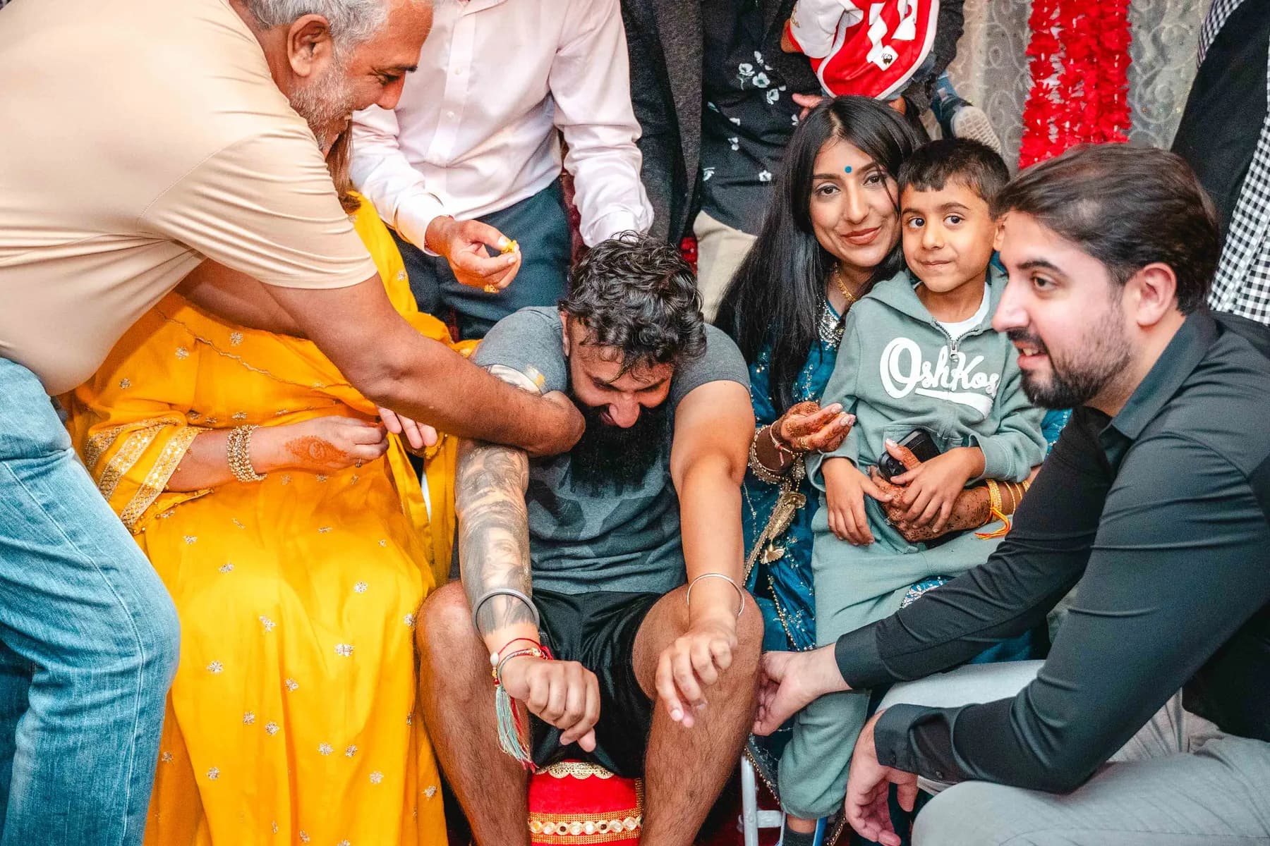 Guests applying colour during the Haldi ceremony at Aaron’s Haldi celebration.