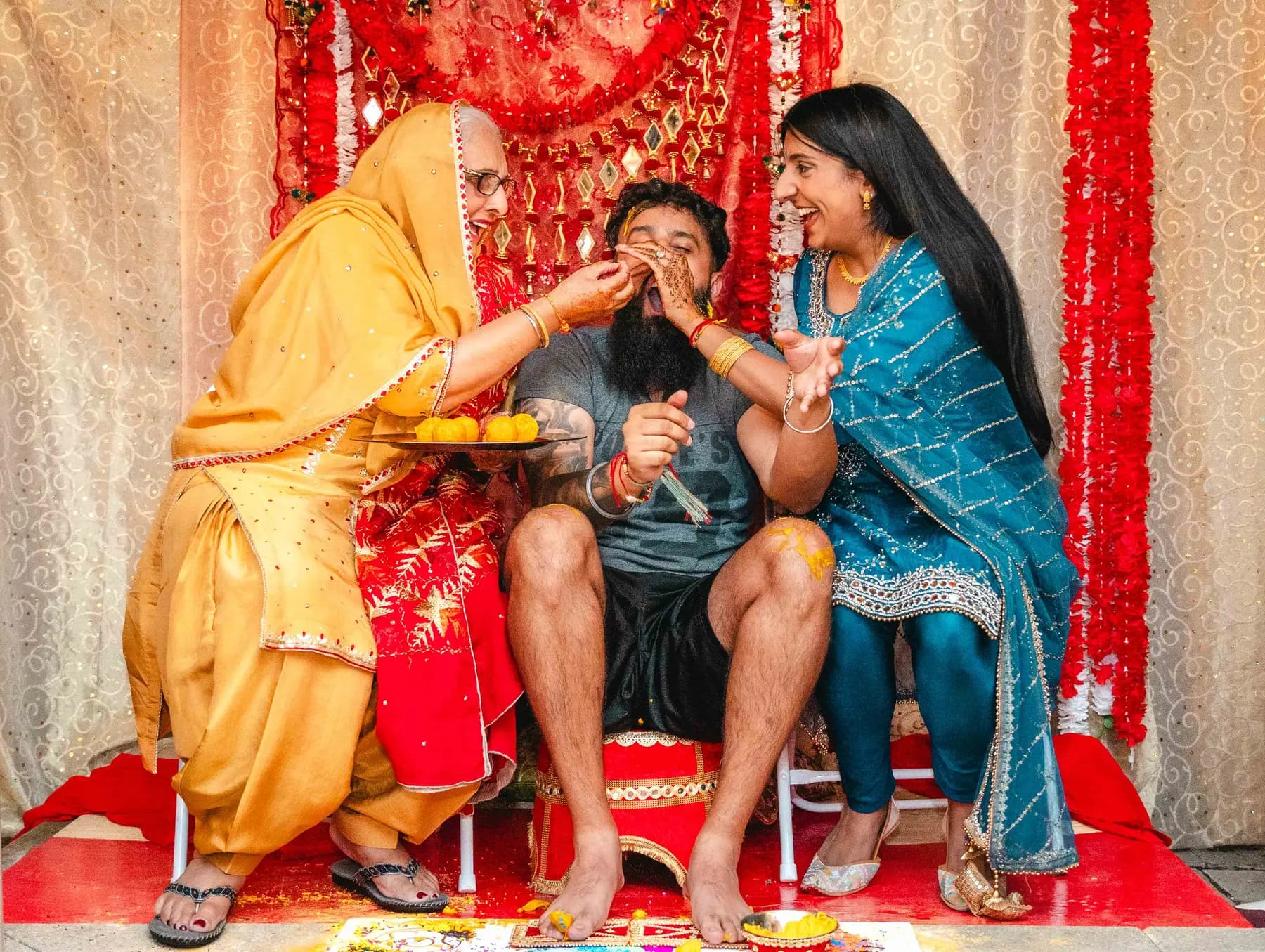 Guests gathered around the Haldi ceremony at Aaron’s Haldi celebration.