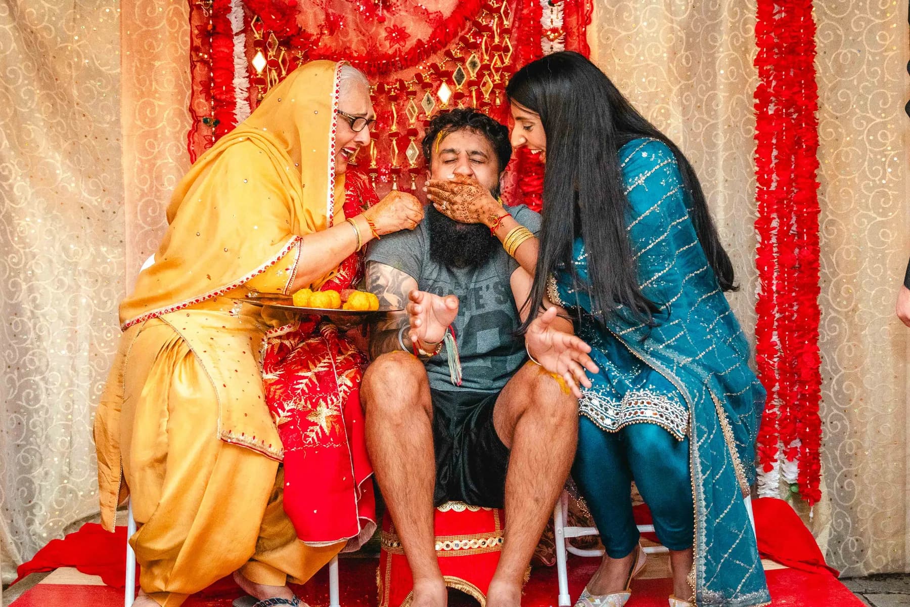 Guests gathered around the Haldi ceremony at Aaron’s Haldi celebration.