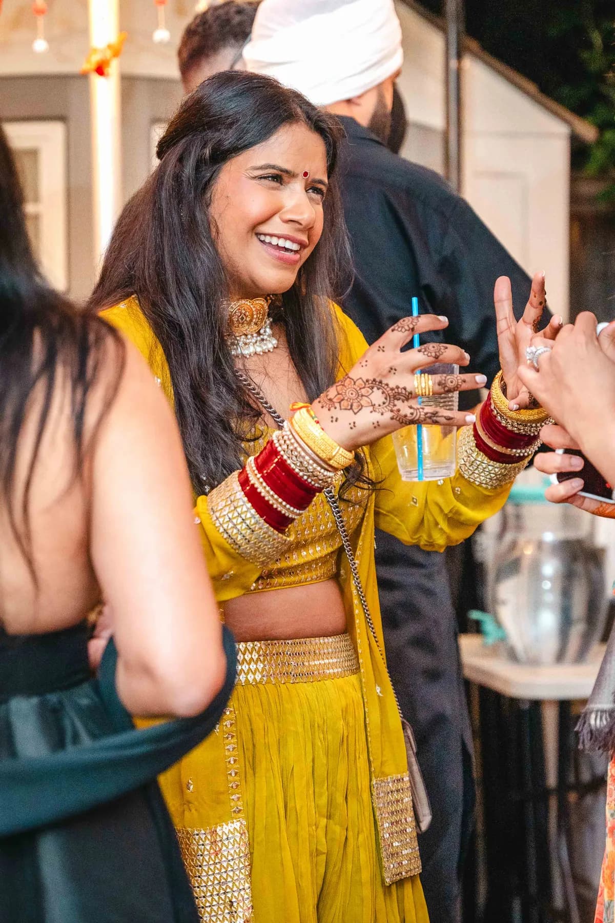 Guests celebrating under evening lights at Aaron’s Haldi celebration.