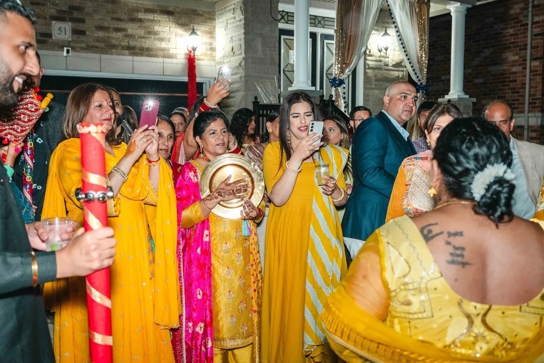 Guests dancing and celebrating outdoors at Aaron’s Haldi celebration.
