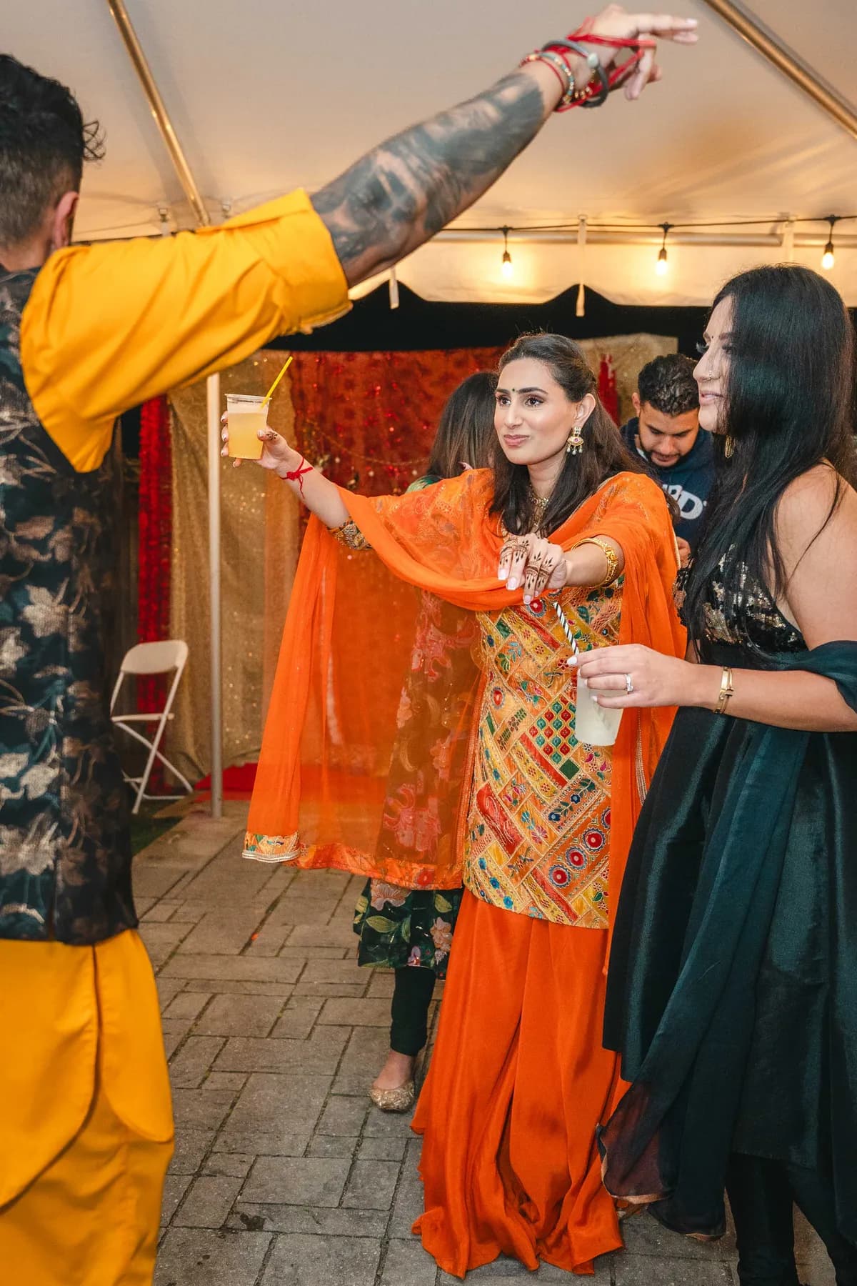 Guests dancing and celebrating outdoors at Aaron’s Haldi celebration.