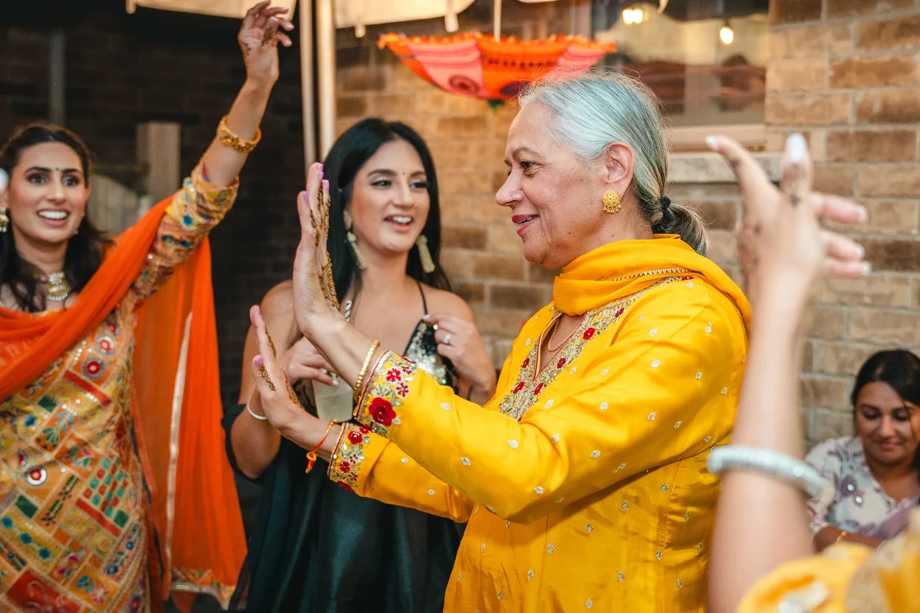 Guests dancing under evening lights at Aaron’s Haldi celebration.