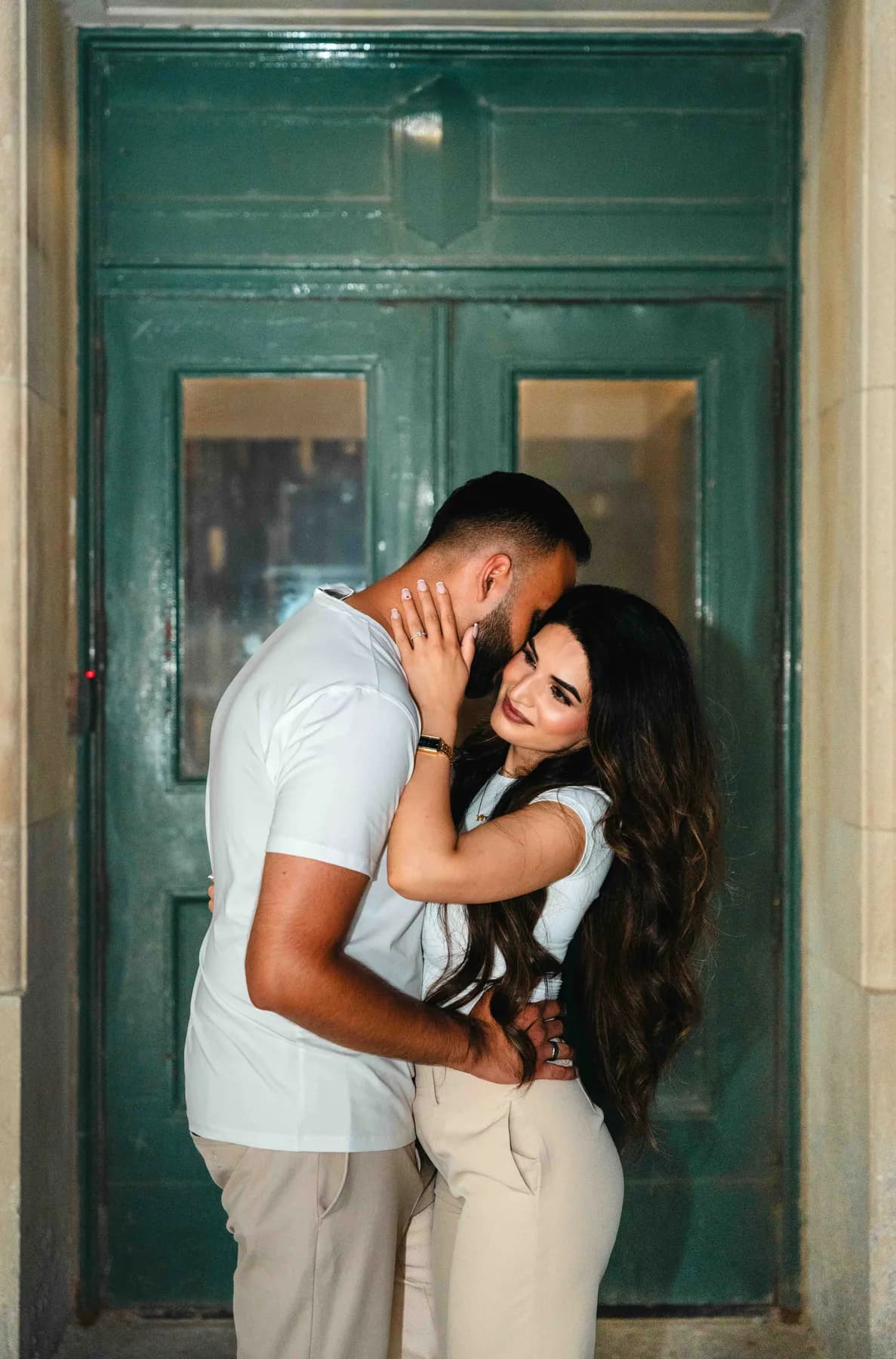 The couple embracing in a doorway at A and F’s couples session.