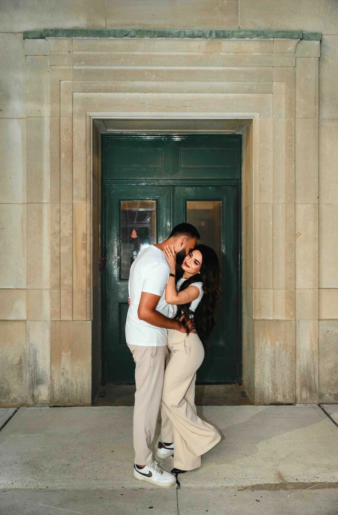 The couple embracing in a doorway at A and F’s couples session.