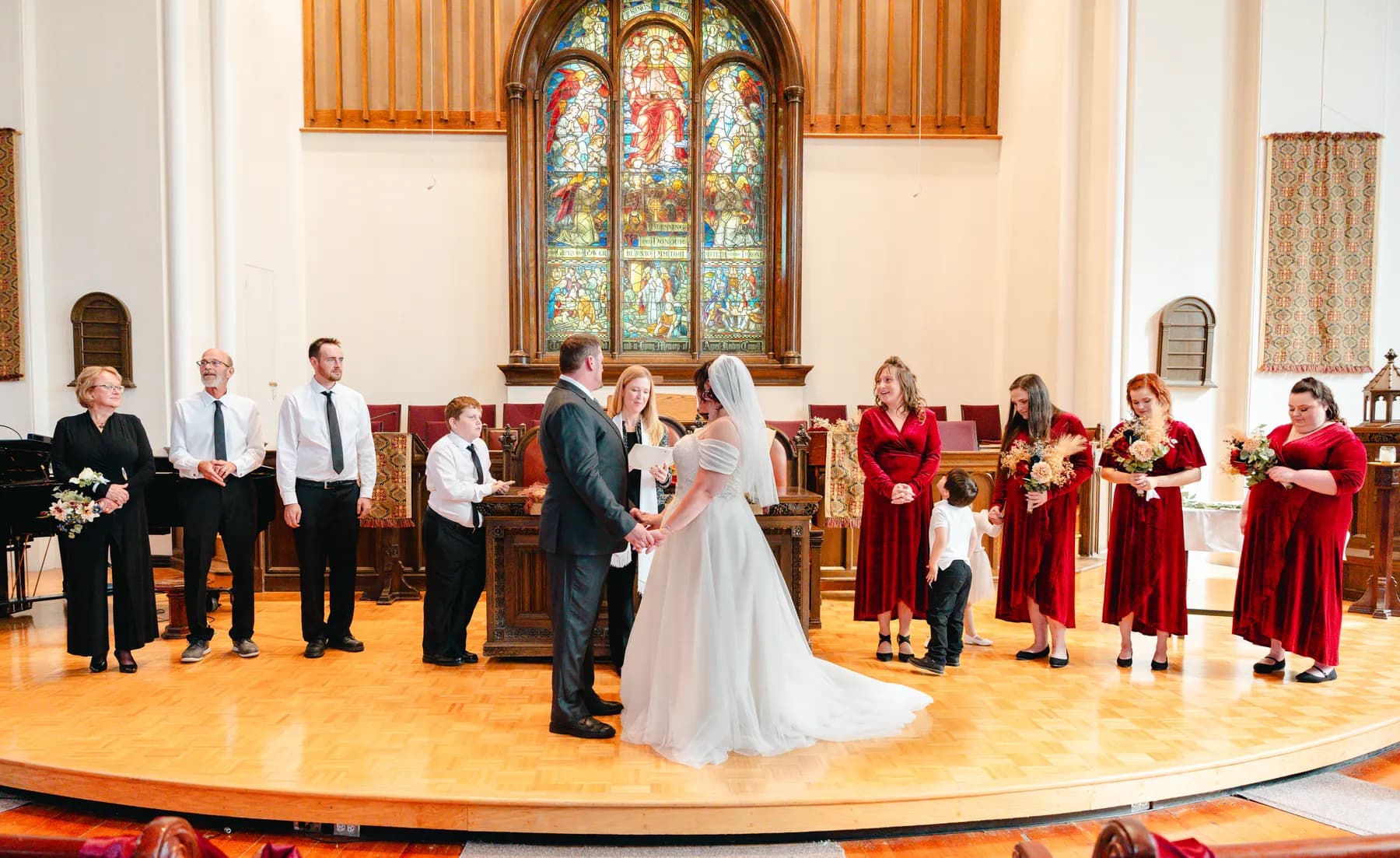 The couple walking down the church aisle after the ceremony at Kody and Jaz’s wedding.