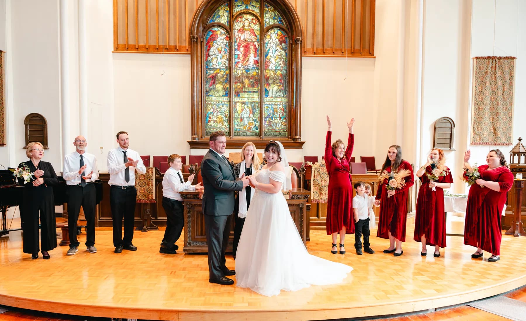 The couple walking down the church aisle after the ceremony at Kody and Jaz’s wedding.
