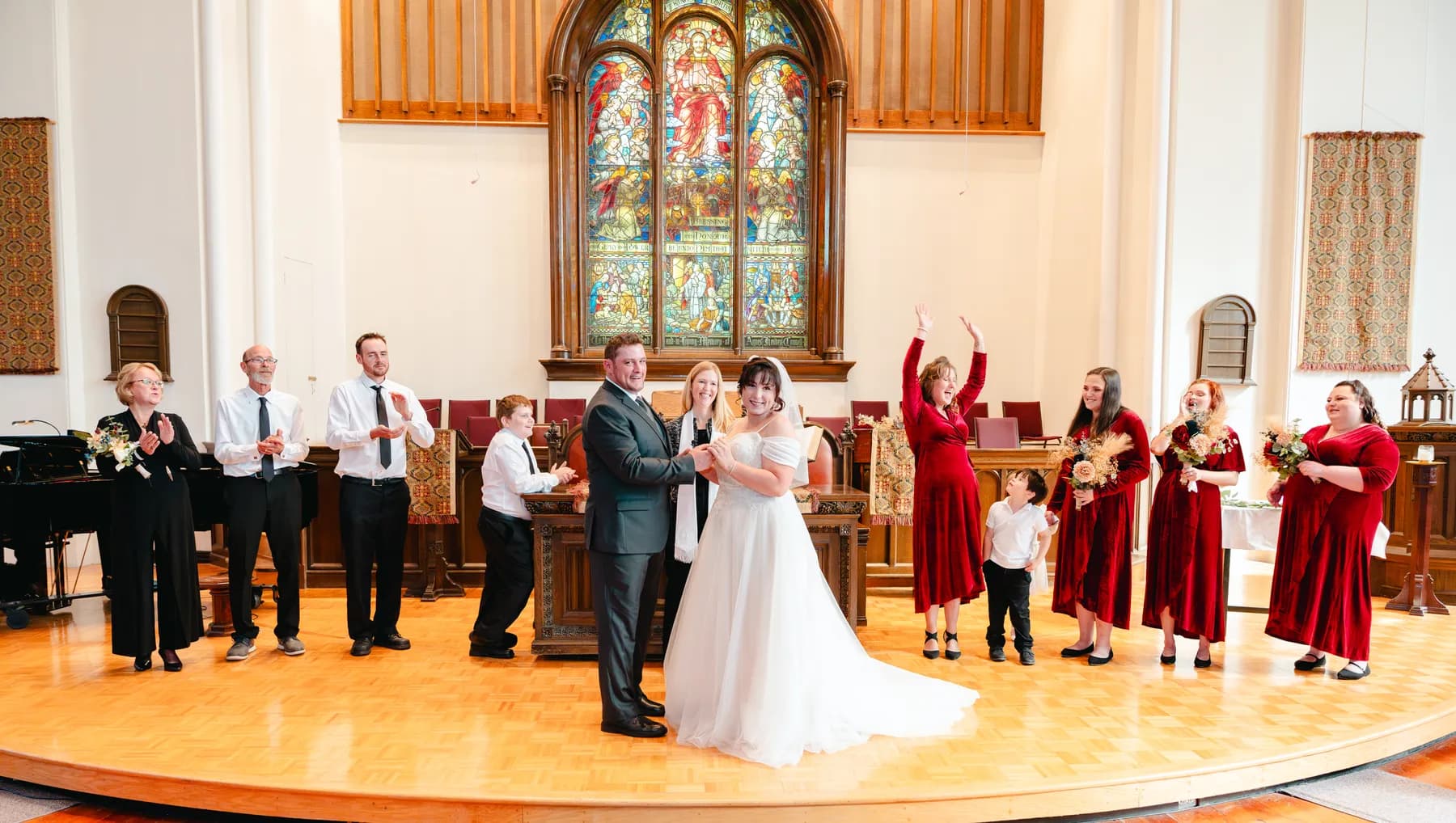 The couple walking down the church aisle after the ceremony at Kody and Jaz’s wedding.