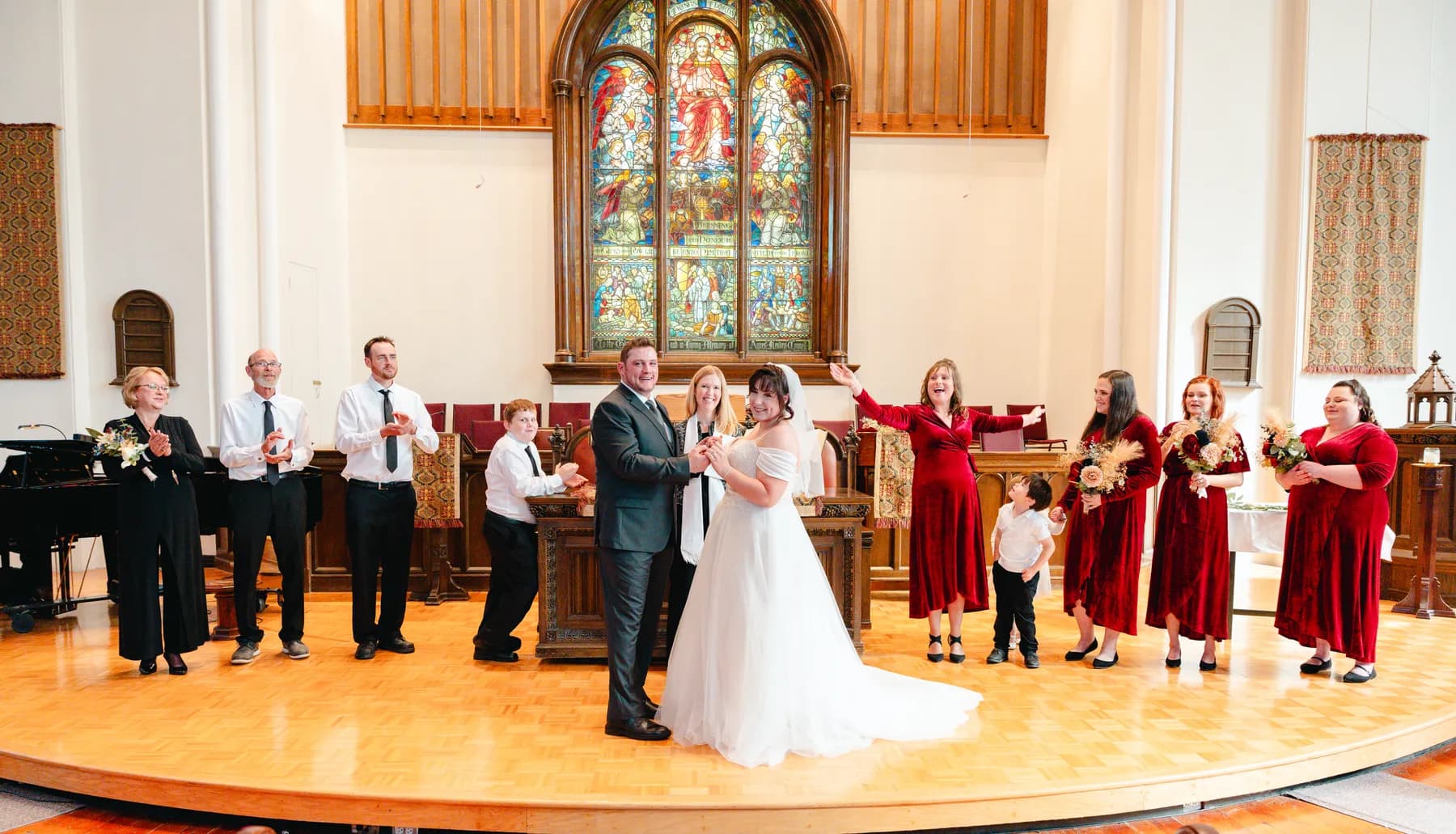 The couple walking down the church aisle after the ceremony at Kody and Jaz’s wedding.
