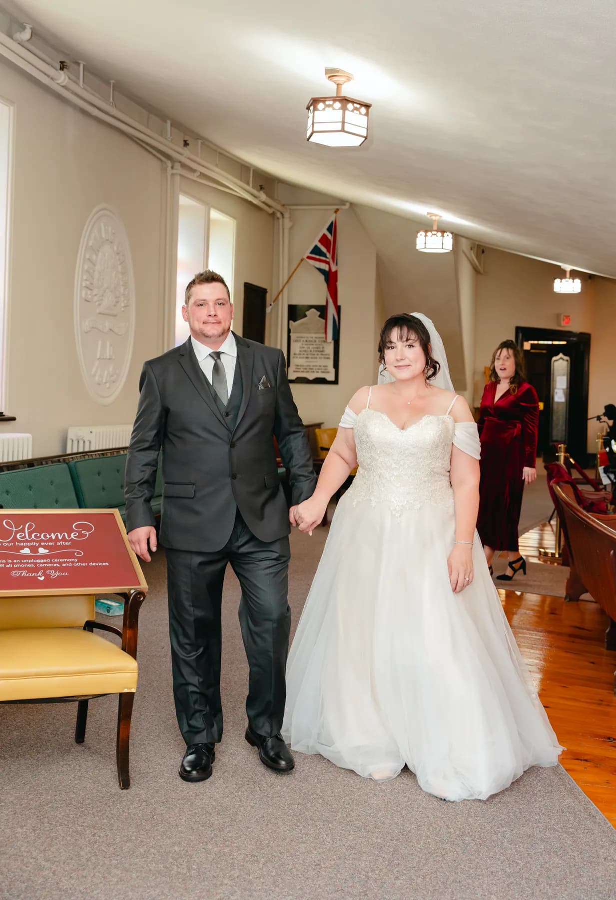The couple walking indoors after the ceremony at Kody and Jaz’s wedding.