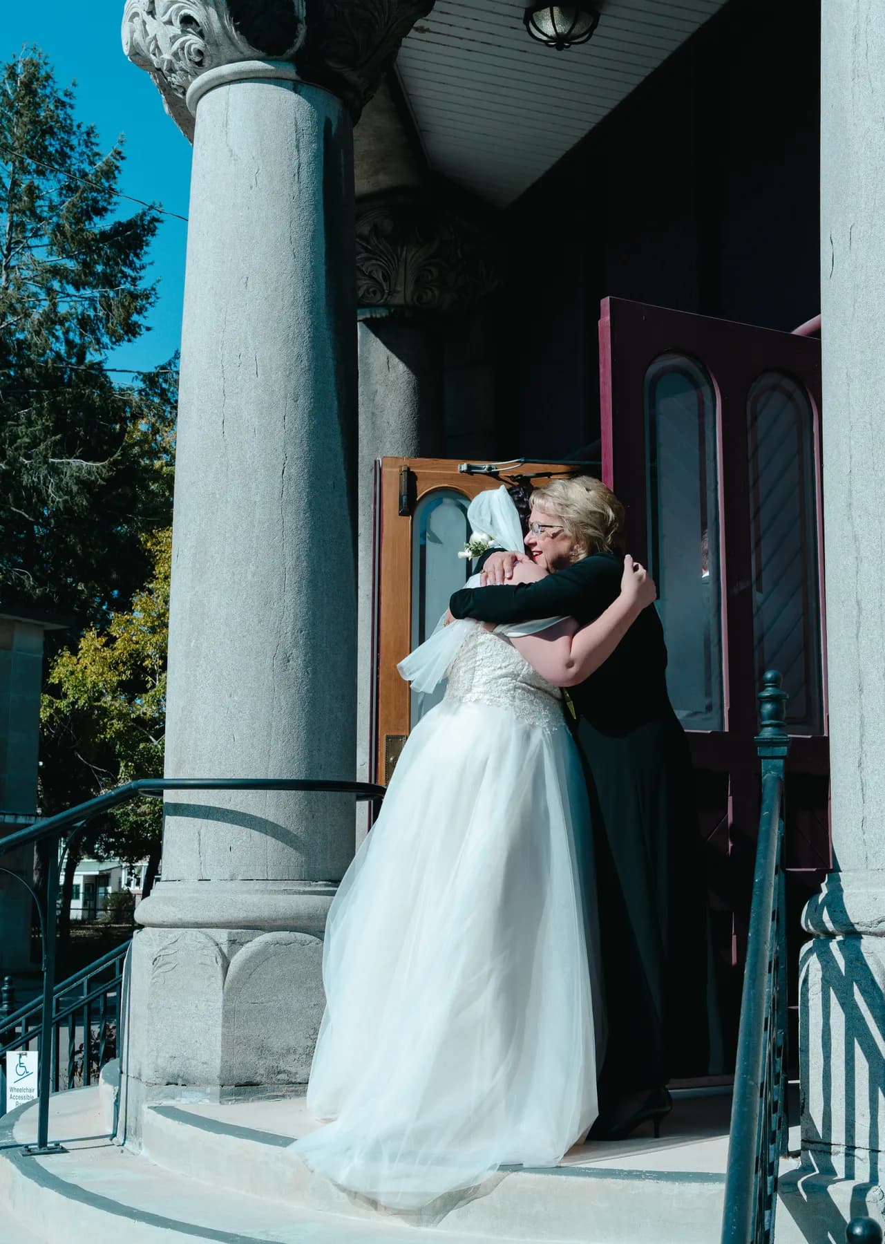 The bride greeting guests outside the church at Kody and Jaz’s wedding.