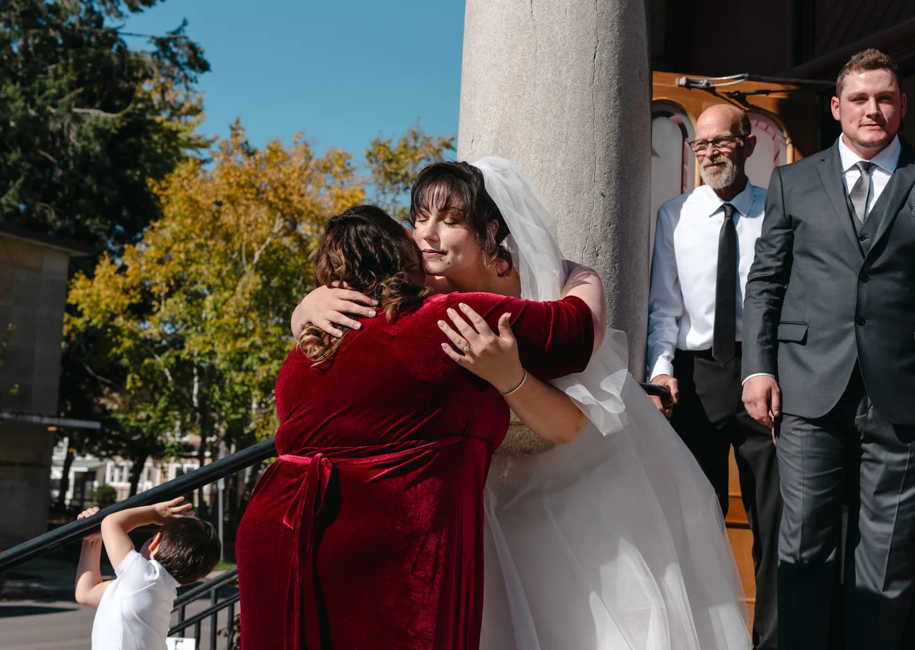 The bride greeting guests outside the church at Kody and Jaz’s wedding.