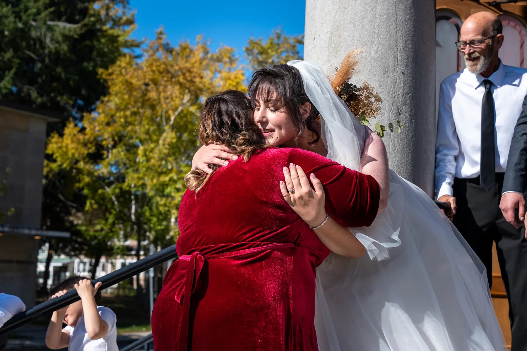 The bride greeting guests outside the church at Kody and Jaz’s wedding.