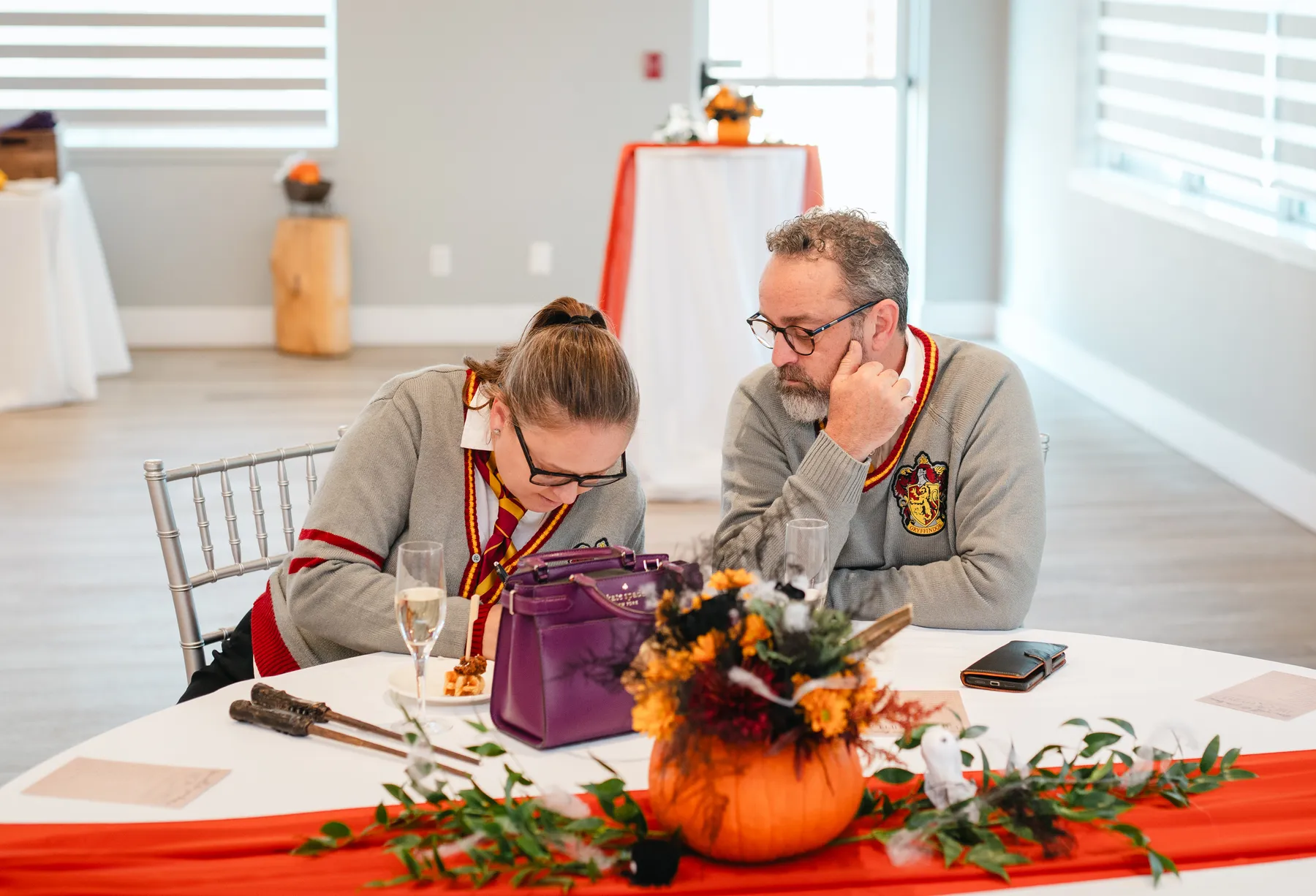 Guests seated and chatting indoors at Jenna and Jake’s Halloween party.