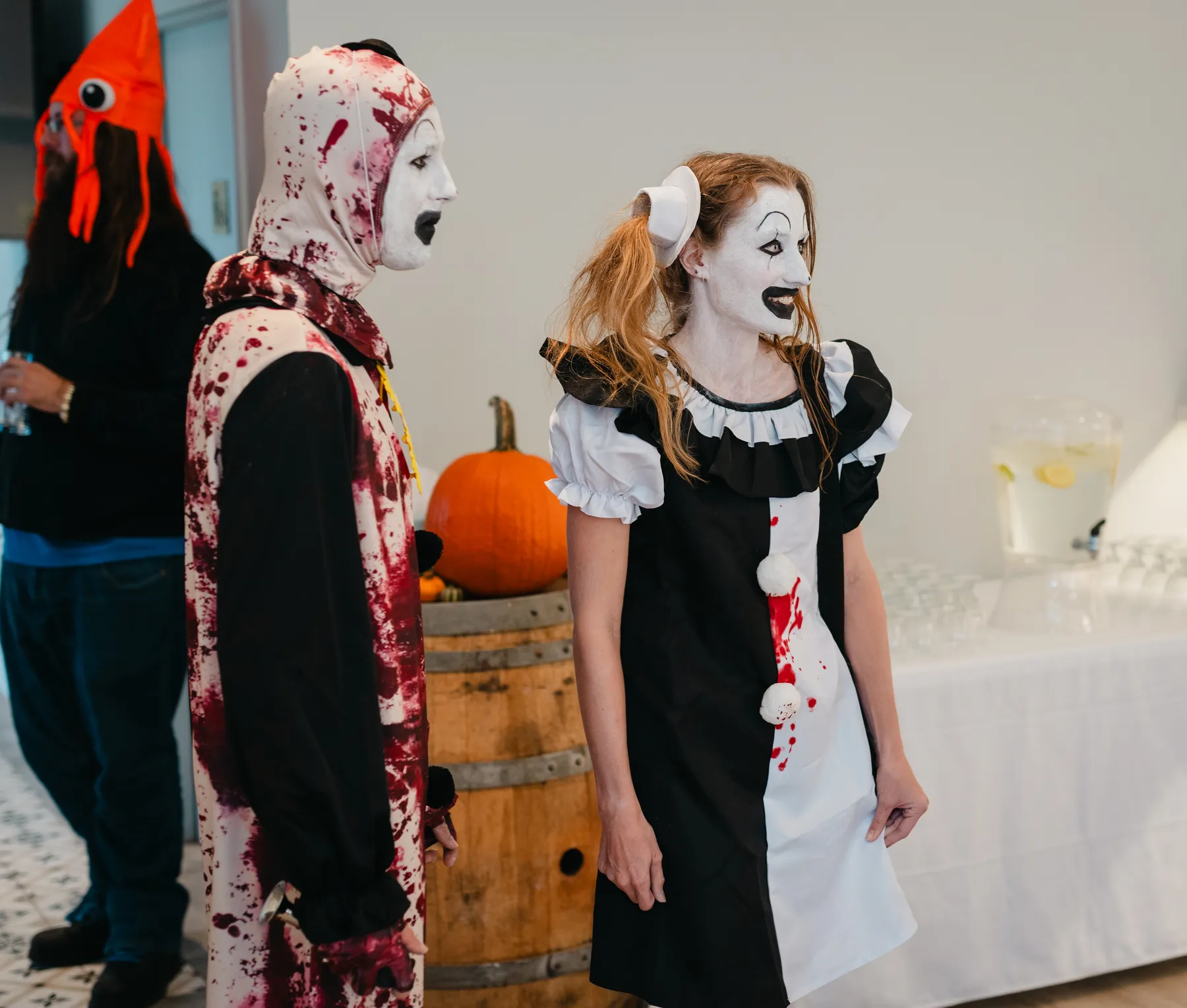 Guests in Halloween costumes talking together at Jenna and Jake’s Halloween party.