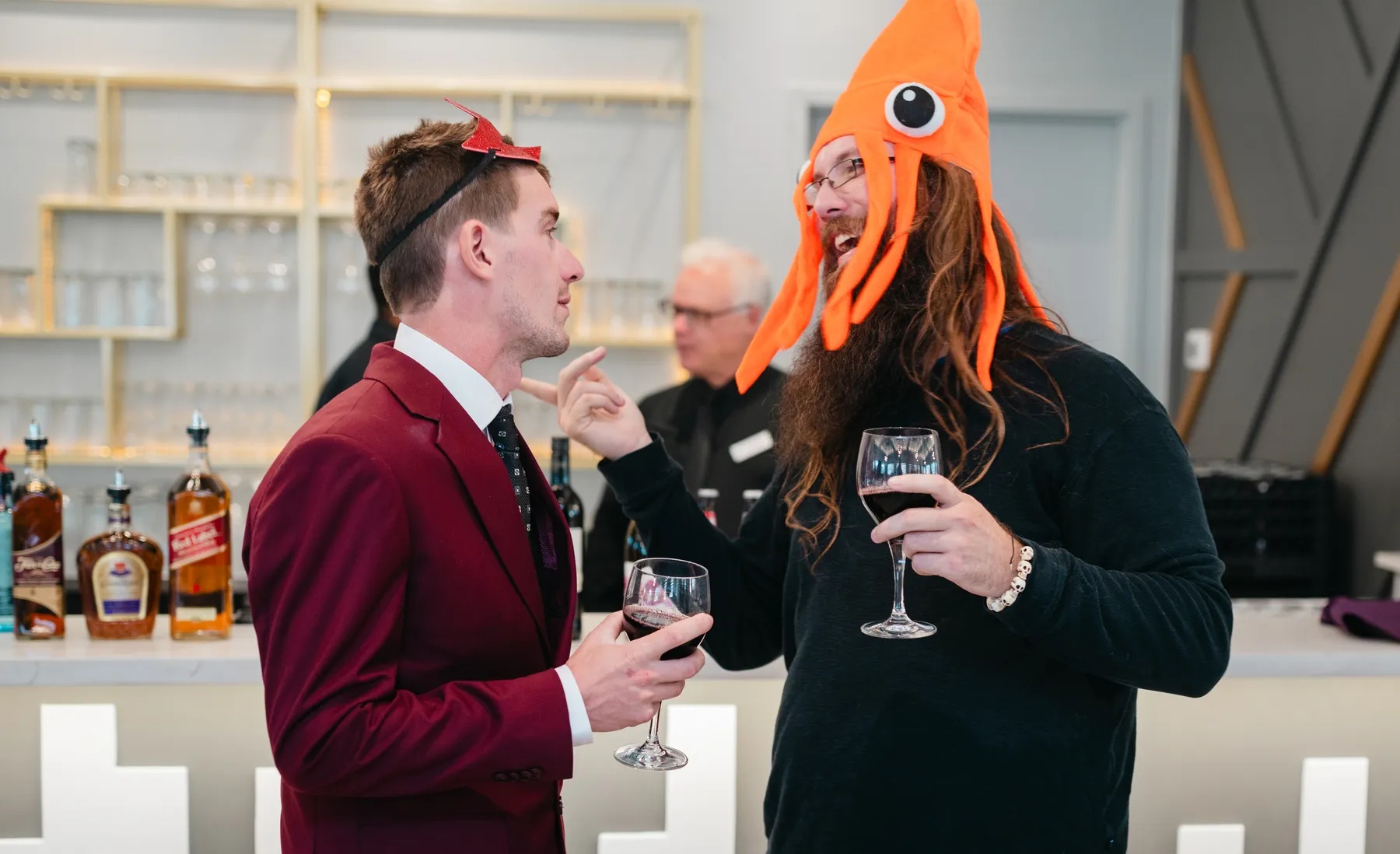 Costumed guests mingling indoors at Jenna and Jake’s Halloween party.