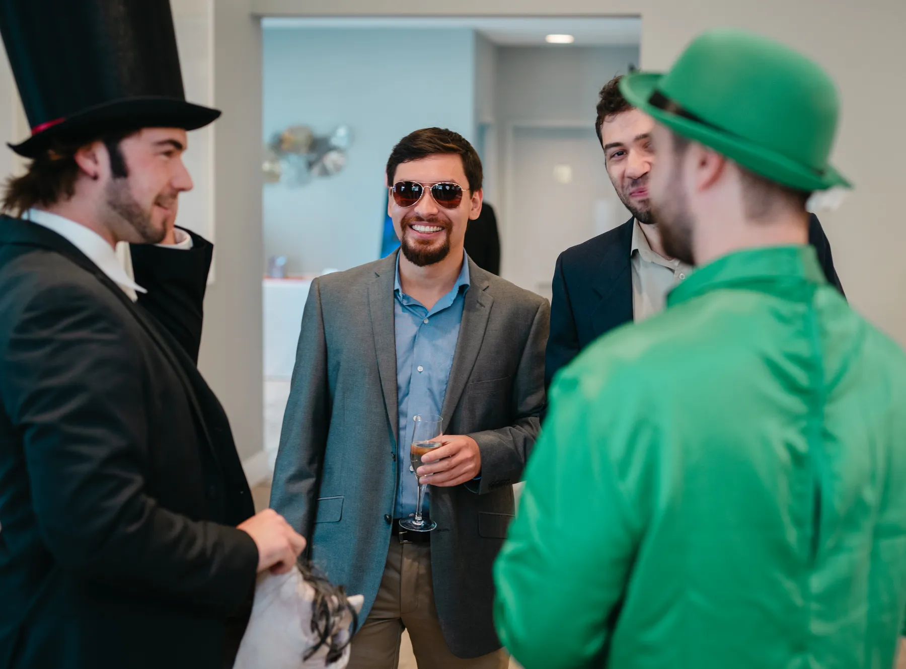 Costumed guests mingling indoors at Jenna and Jake’s Halloween party.
