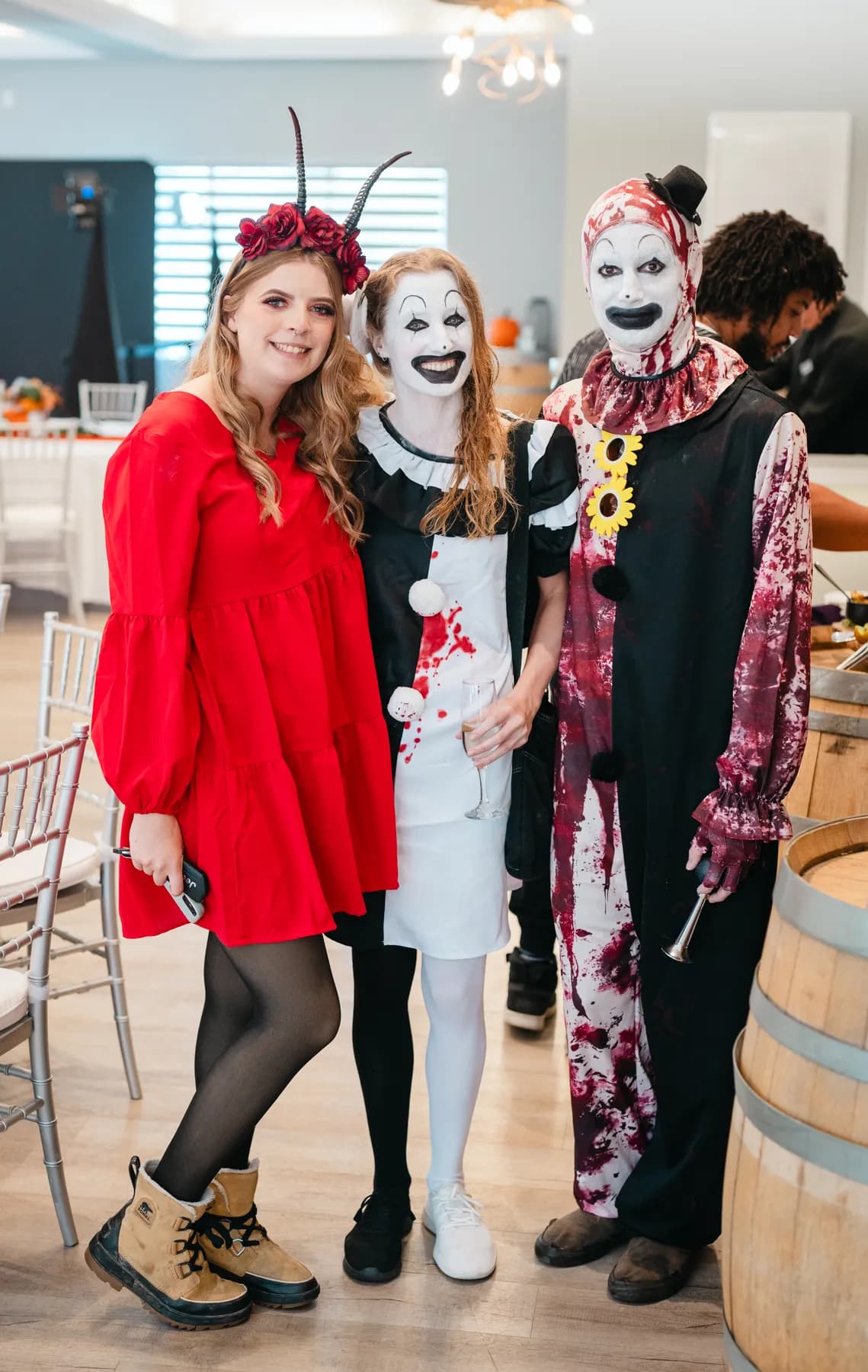 Costumed guests chatting and posing at Jenna and Jake’s Halloween party.