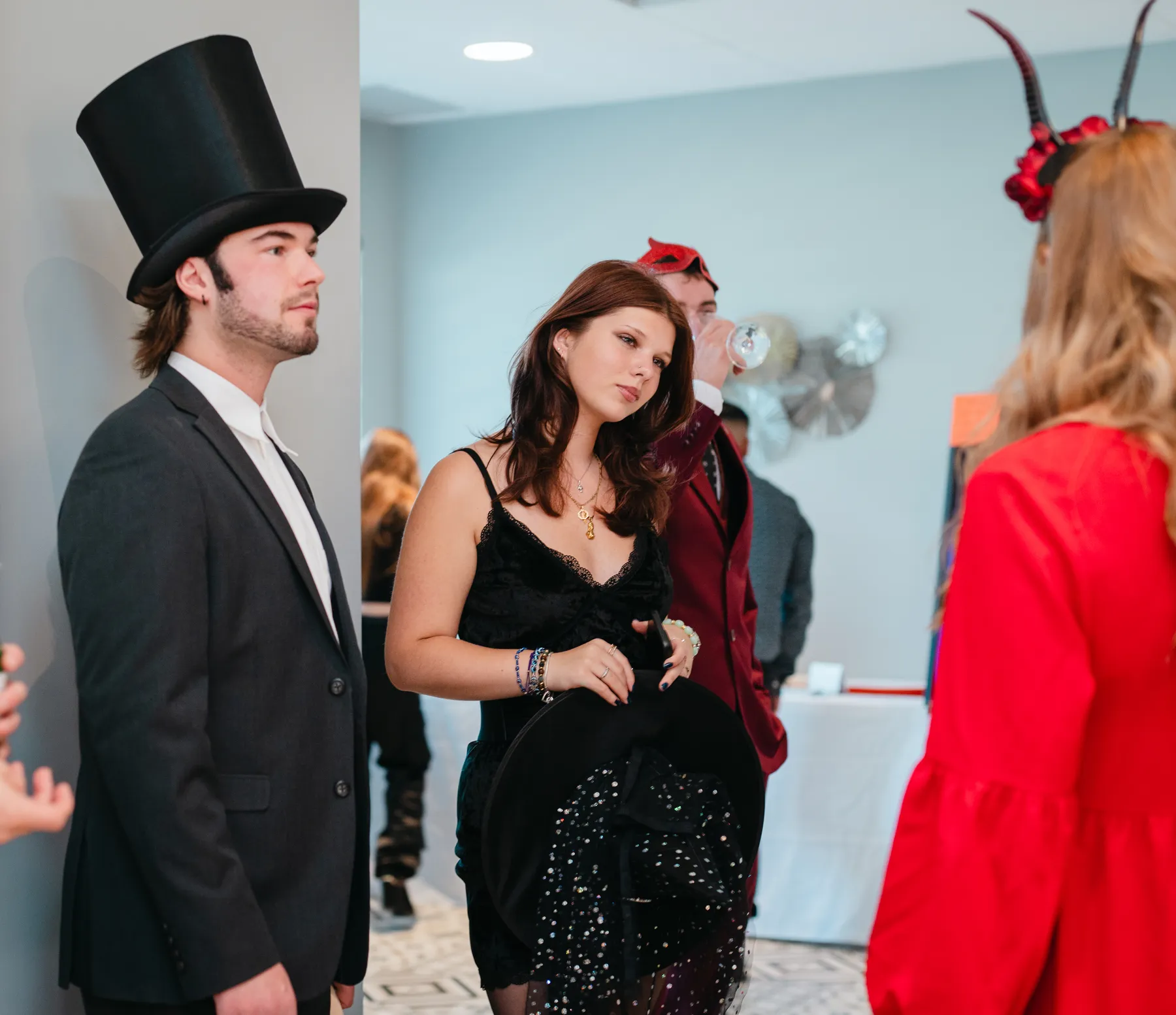 Costumed guests chatting and posing at Jenna and Jake’s Halloween party.