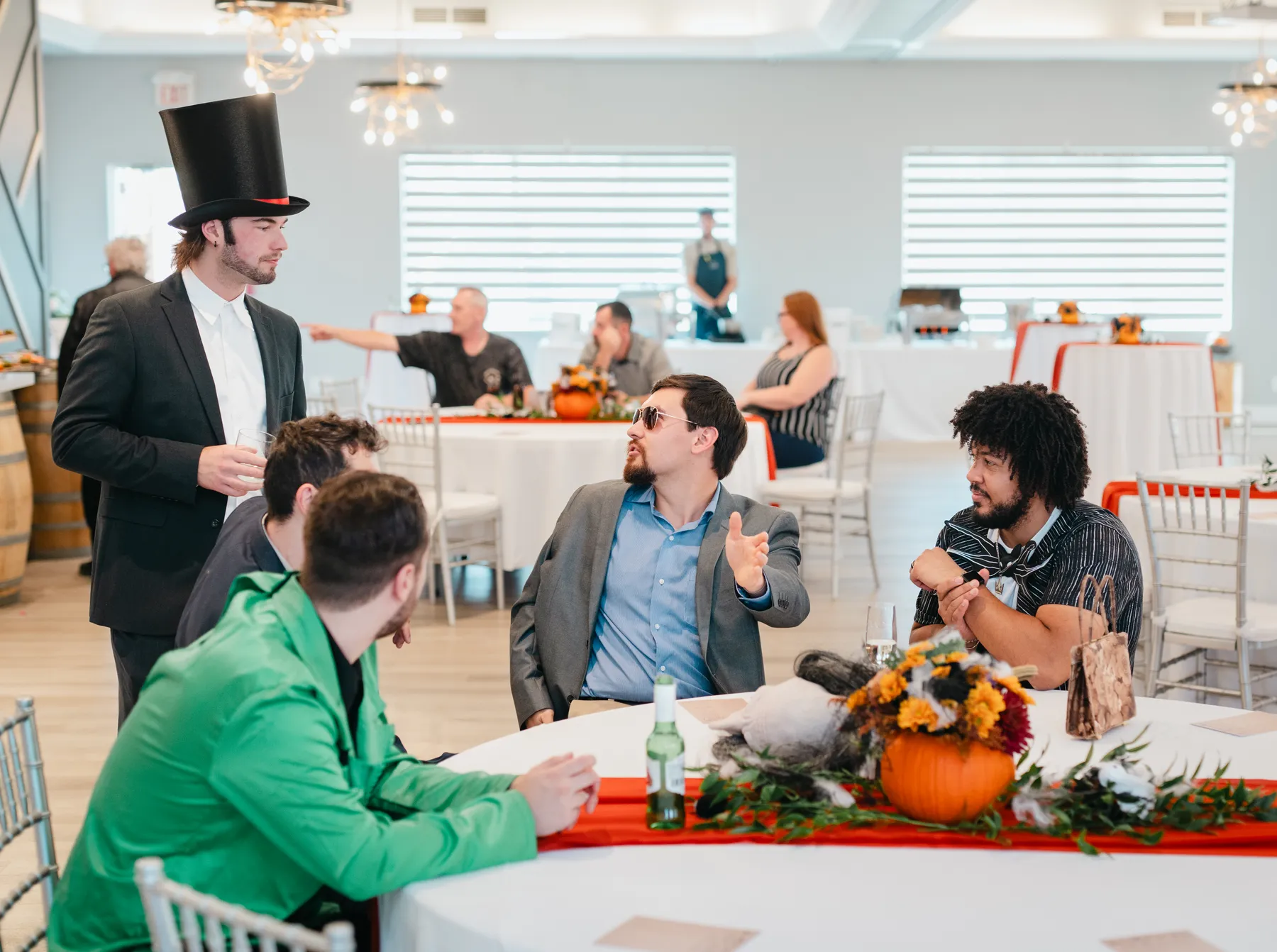 Costumed guests socializing and posing at Jenna and Jake’s Halloween party.