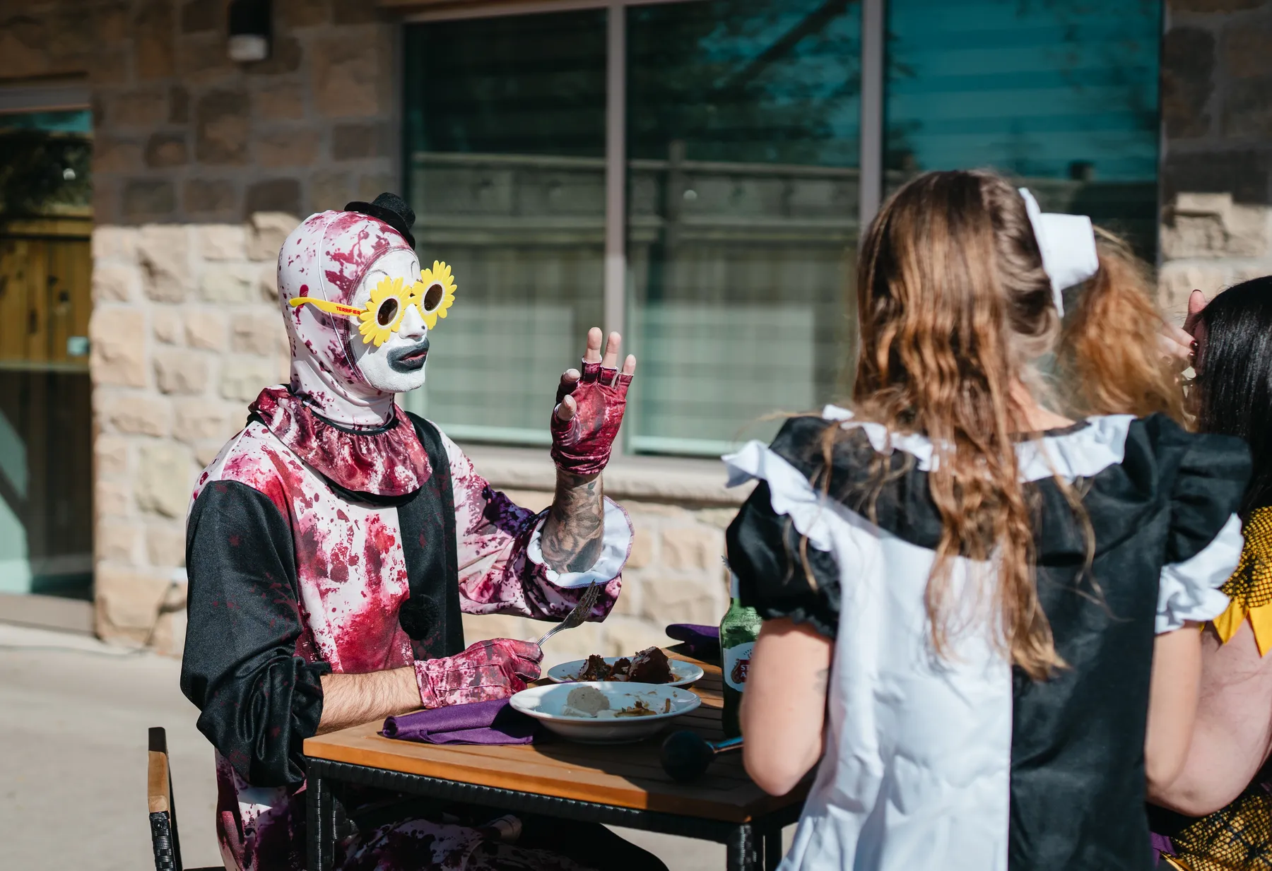 Costumed guests gathered near a table at Jenna and Jake’s Halloween party.