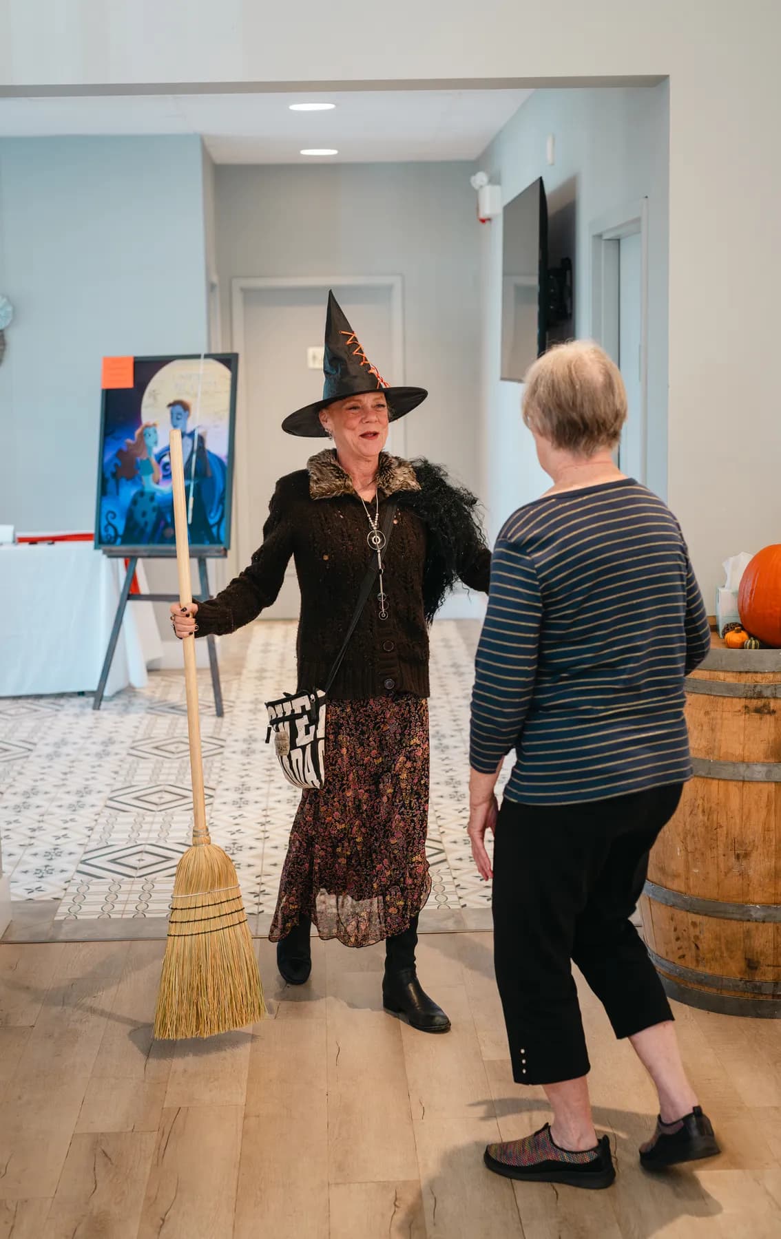 Costumed guests posing and socializing indoors at Jenna and Jake’s Halloween party.