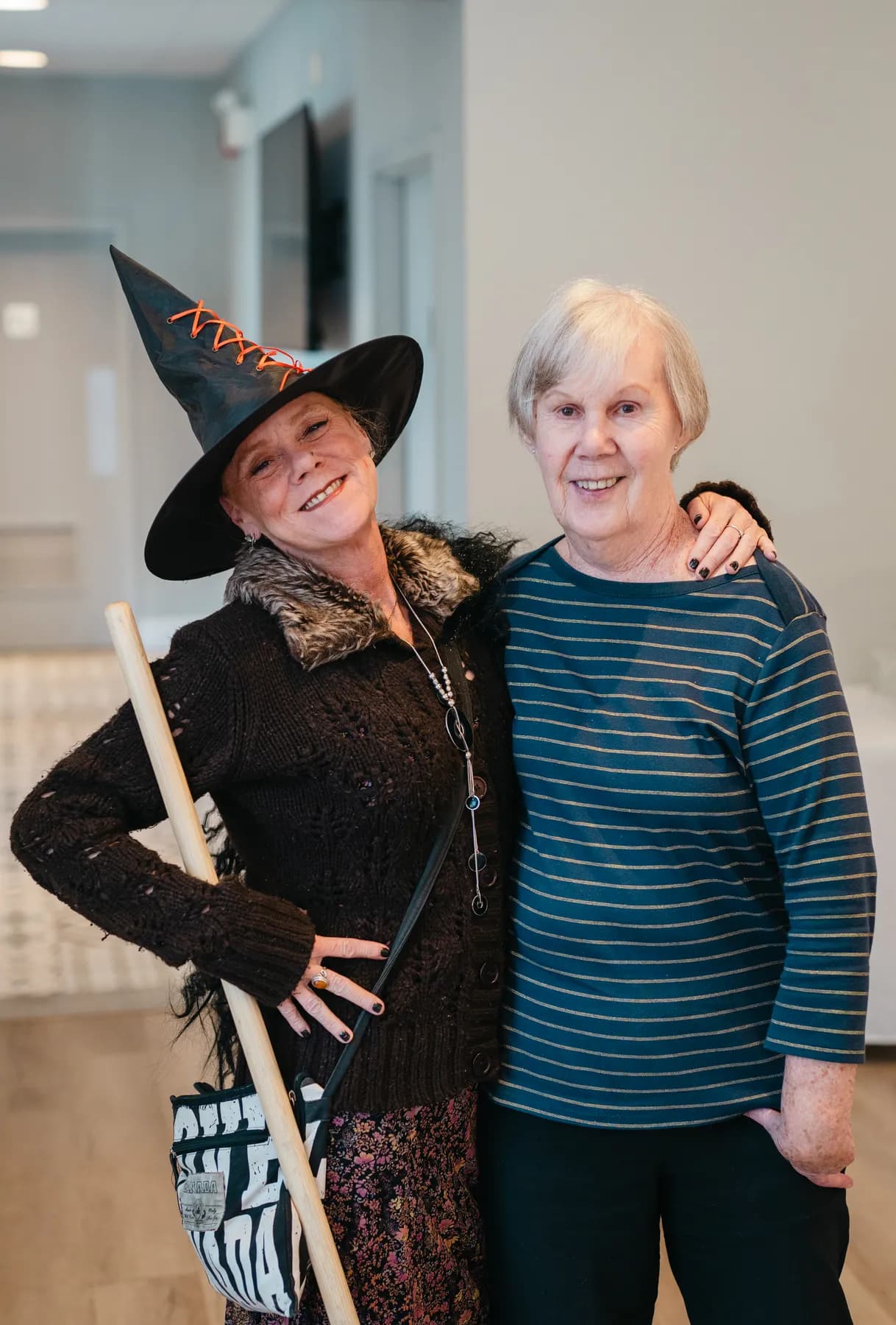 Costumed guests posing and socializing indoors at Jenna and Jake’s Halloween party.