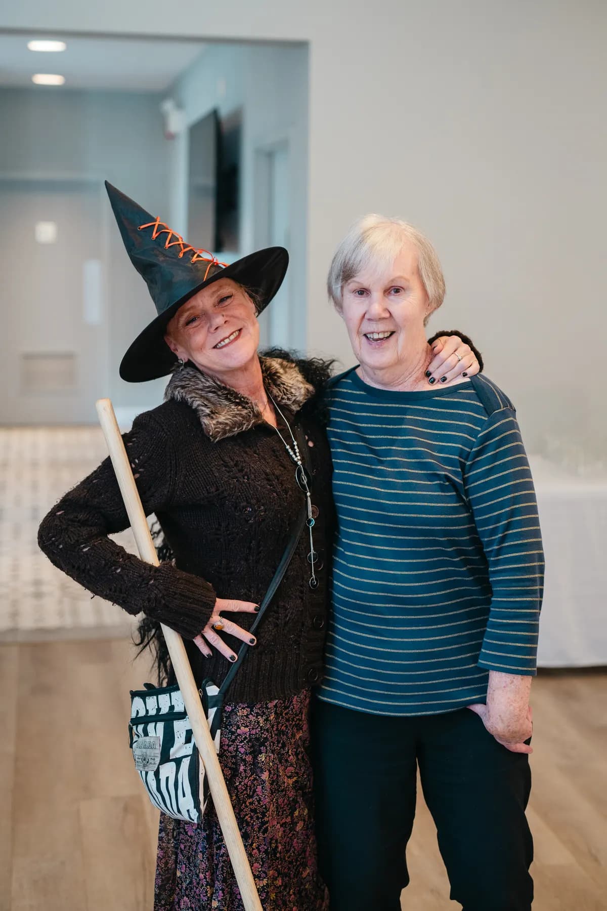 Costumed guests posing and socializing indoors at Jenna and Jake’s Halloween party.