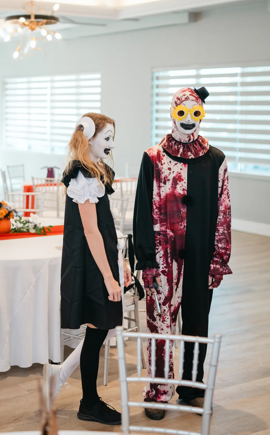 Costumed guests posing and socializing indoors at Jenna and Jake’s Halloween party.