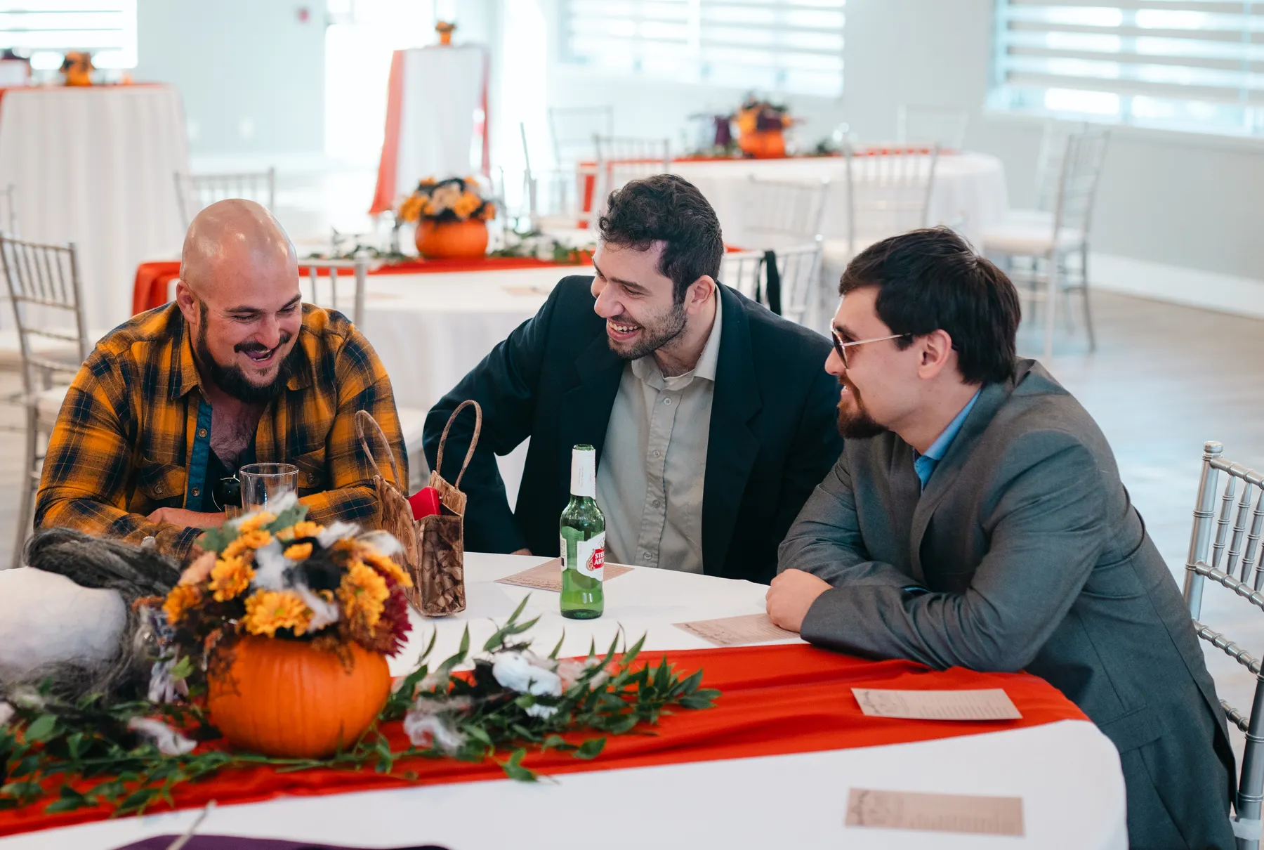 Guests mingling around a table at Jenna and Jake’s Halloween party.