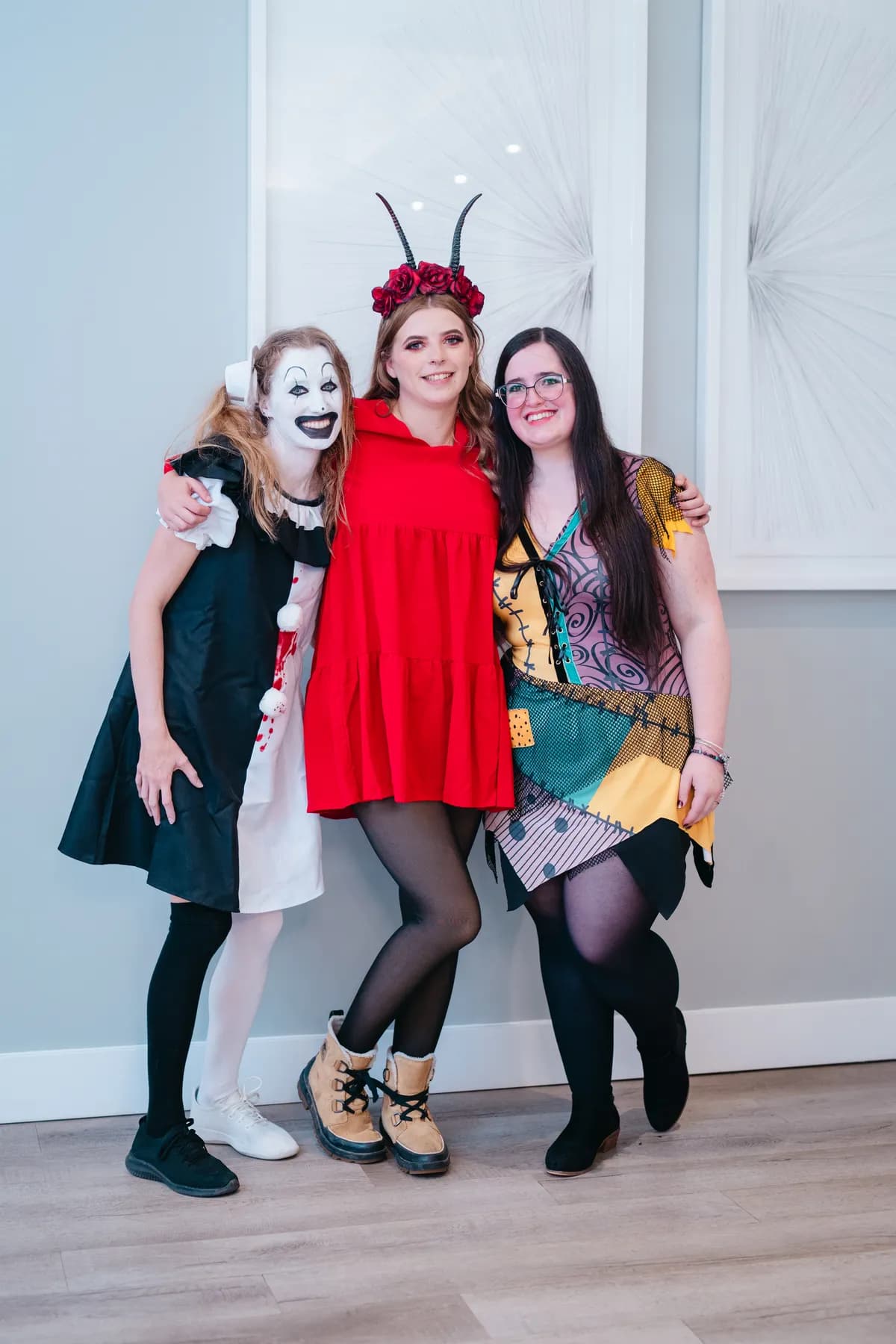 Groups of costumed guests posing indoors at Jenna and Jake’s Halloween party.