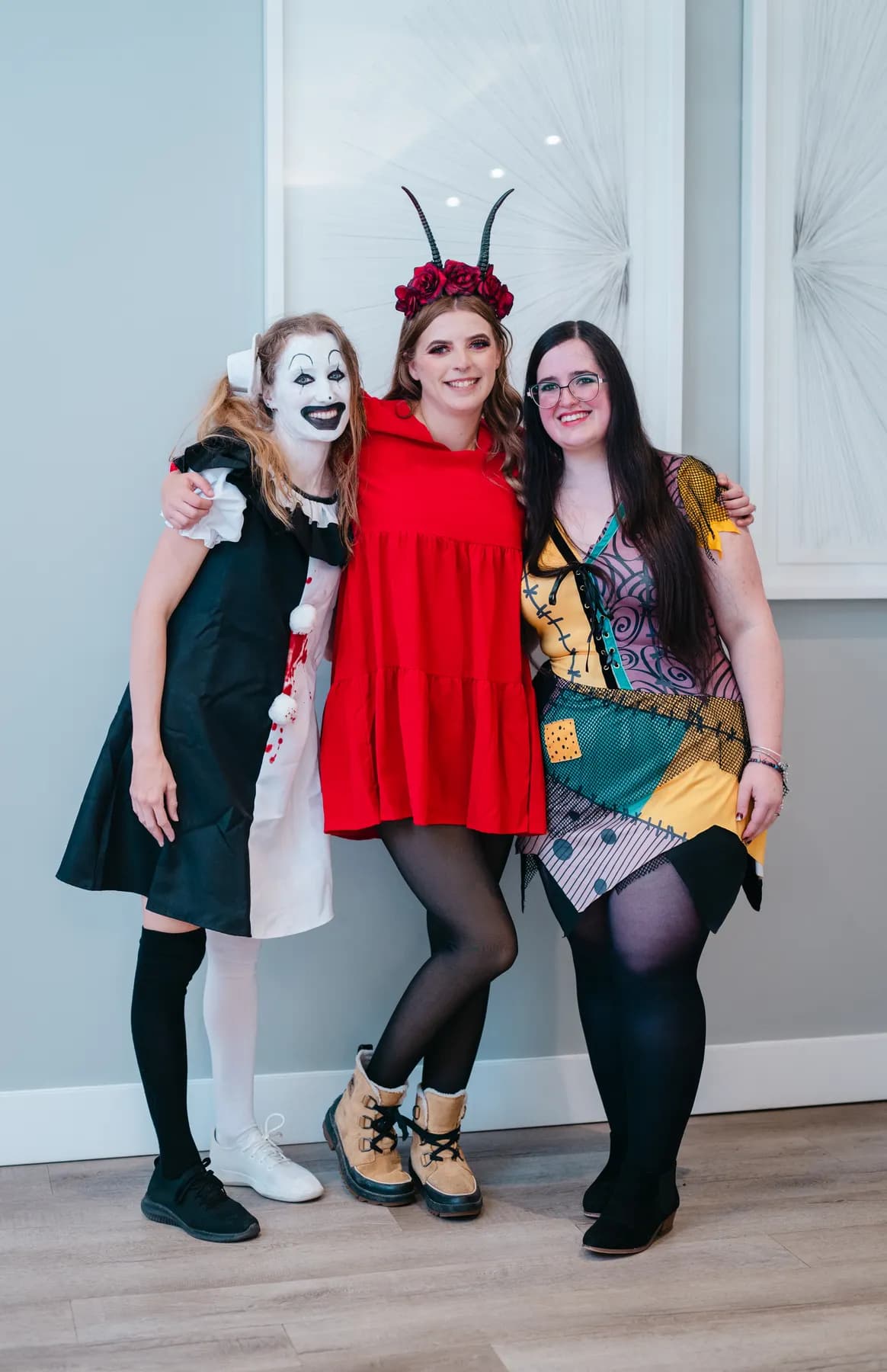 Groups of costumed guests posing indoors at Jenna and Jake’s Halloween party.