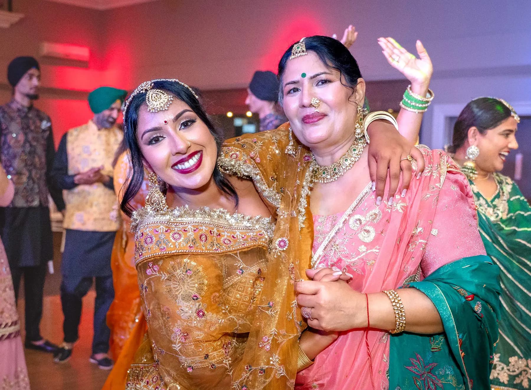 Two women smiling together at Jessie and Erin’s Haldi celebration.