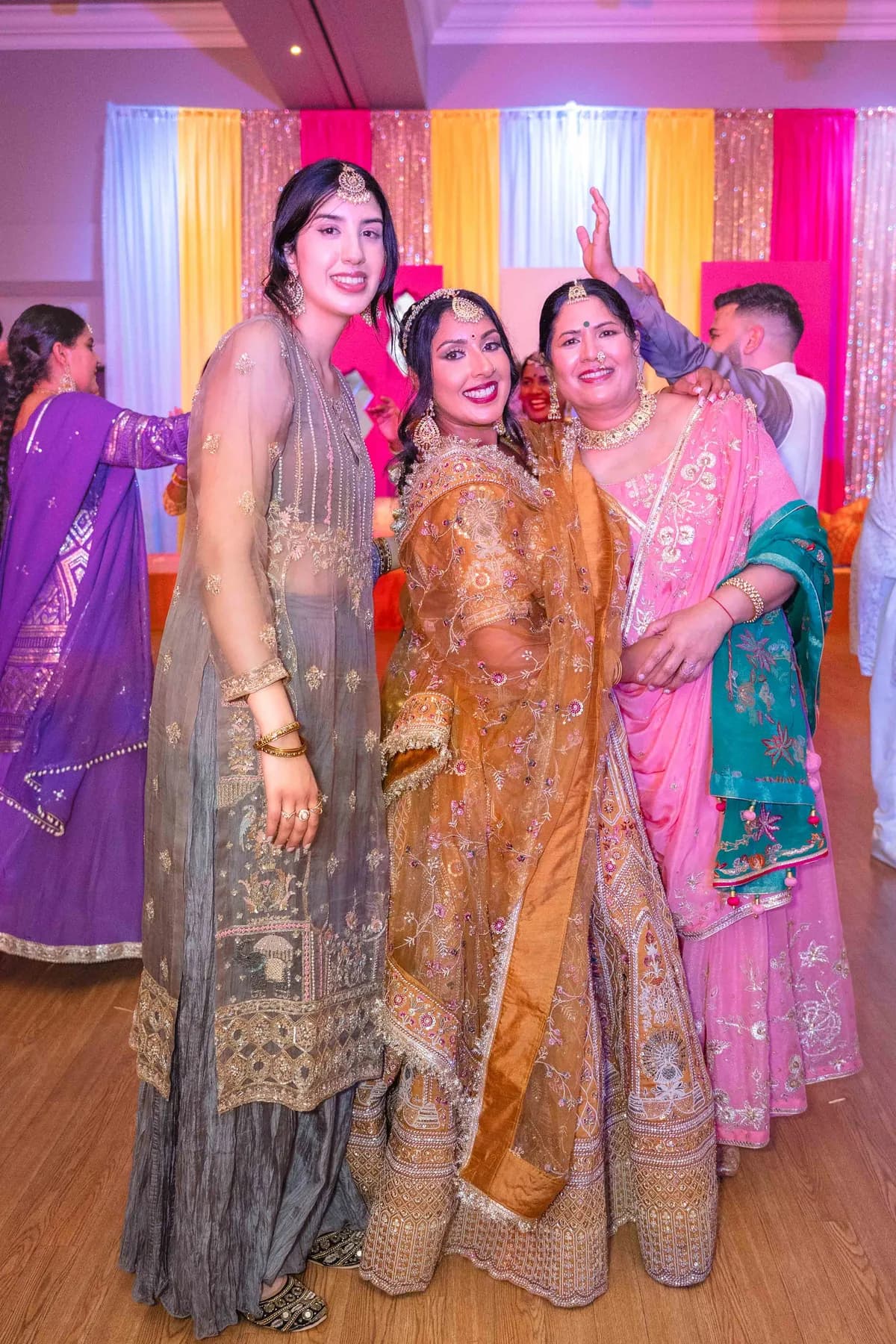 Guests posing together at Jessie and Erin’s Haldi celebration.