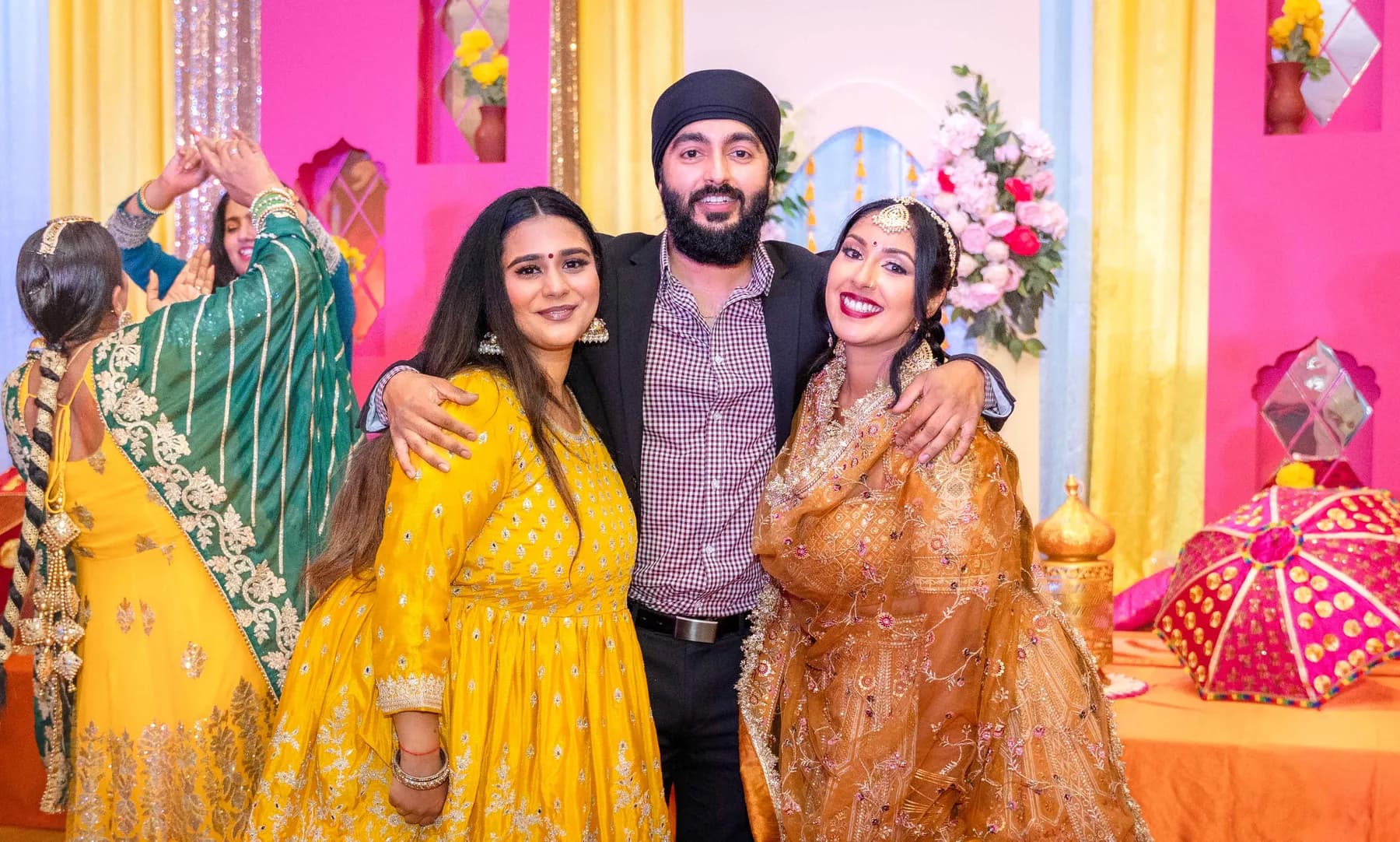 Guests posing together at Jessie and Erin’s Haldi celebration.
