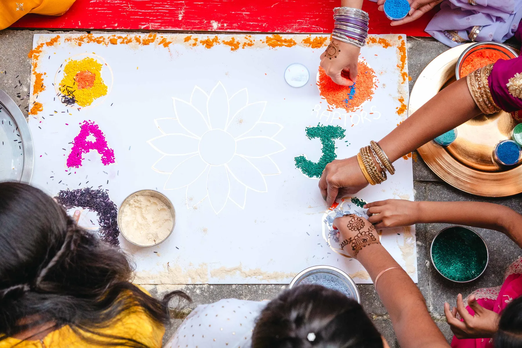 Colourful ceremonial artwork viewed from above at Aaron’s Haldi celebration.
