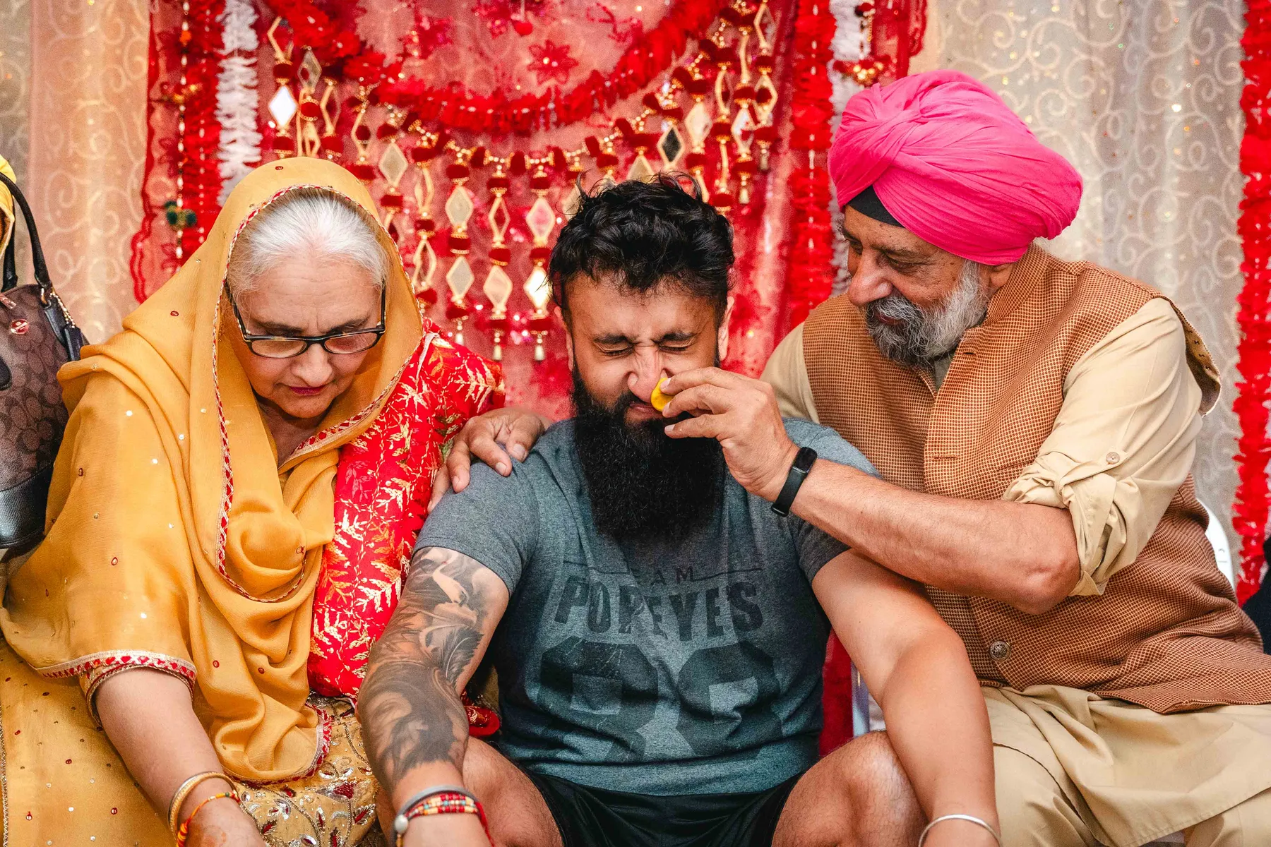 Guests applying colour during the Haldi ceremony at Aaron’s Haldi celebration.